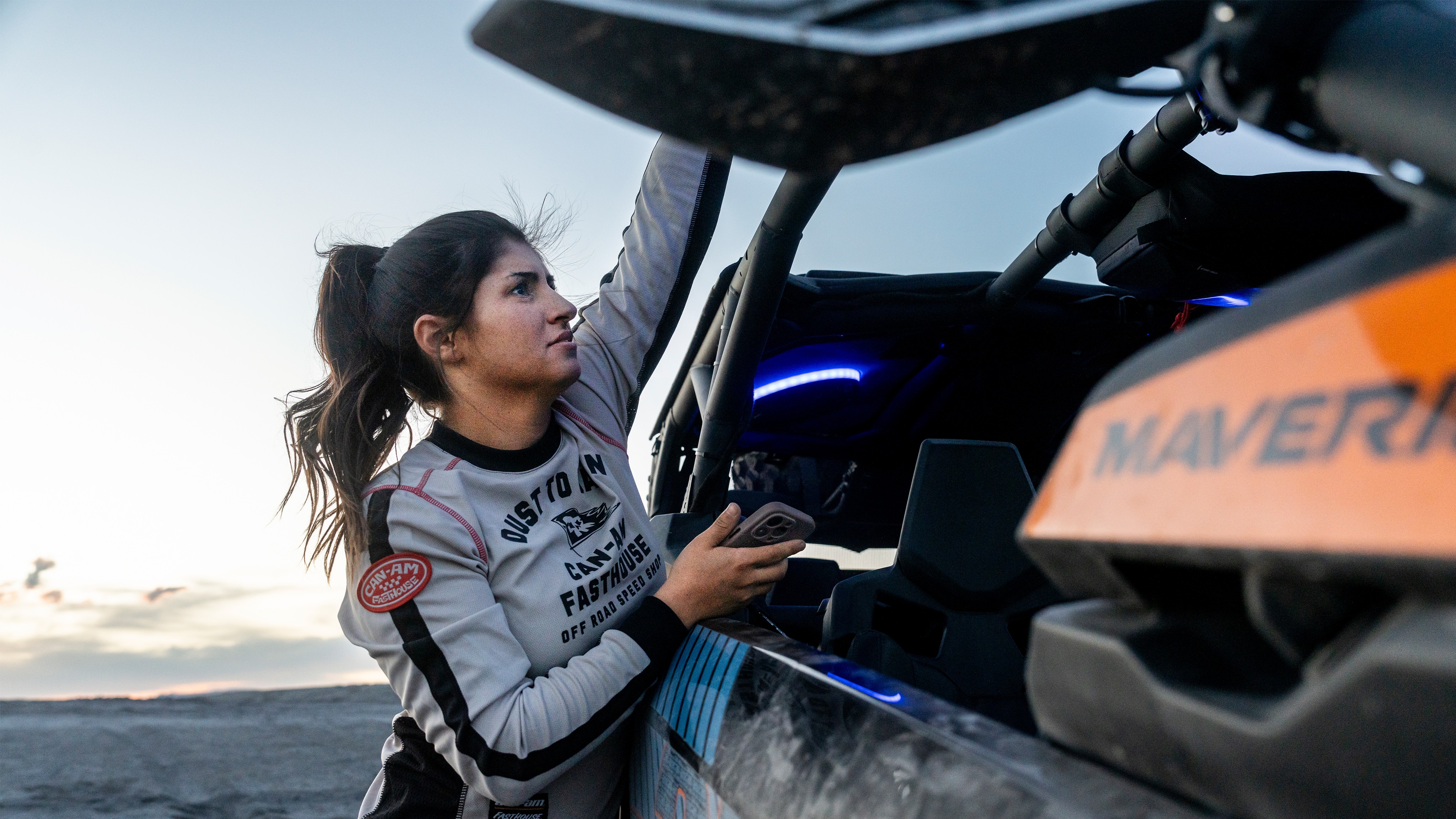 A woman next to a Can-Am Maverick X3