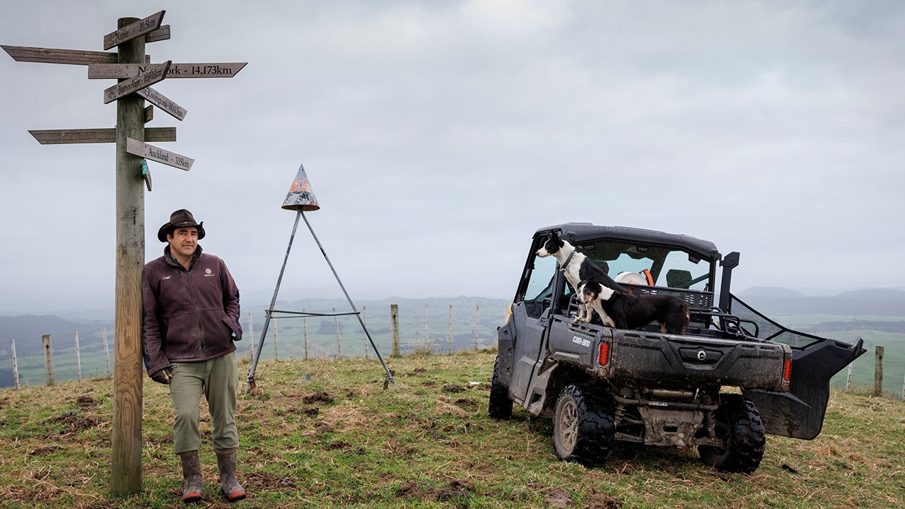 Farmer leaning on a post with a Can-Am Defender