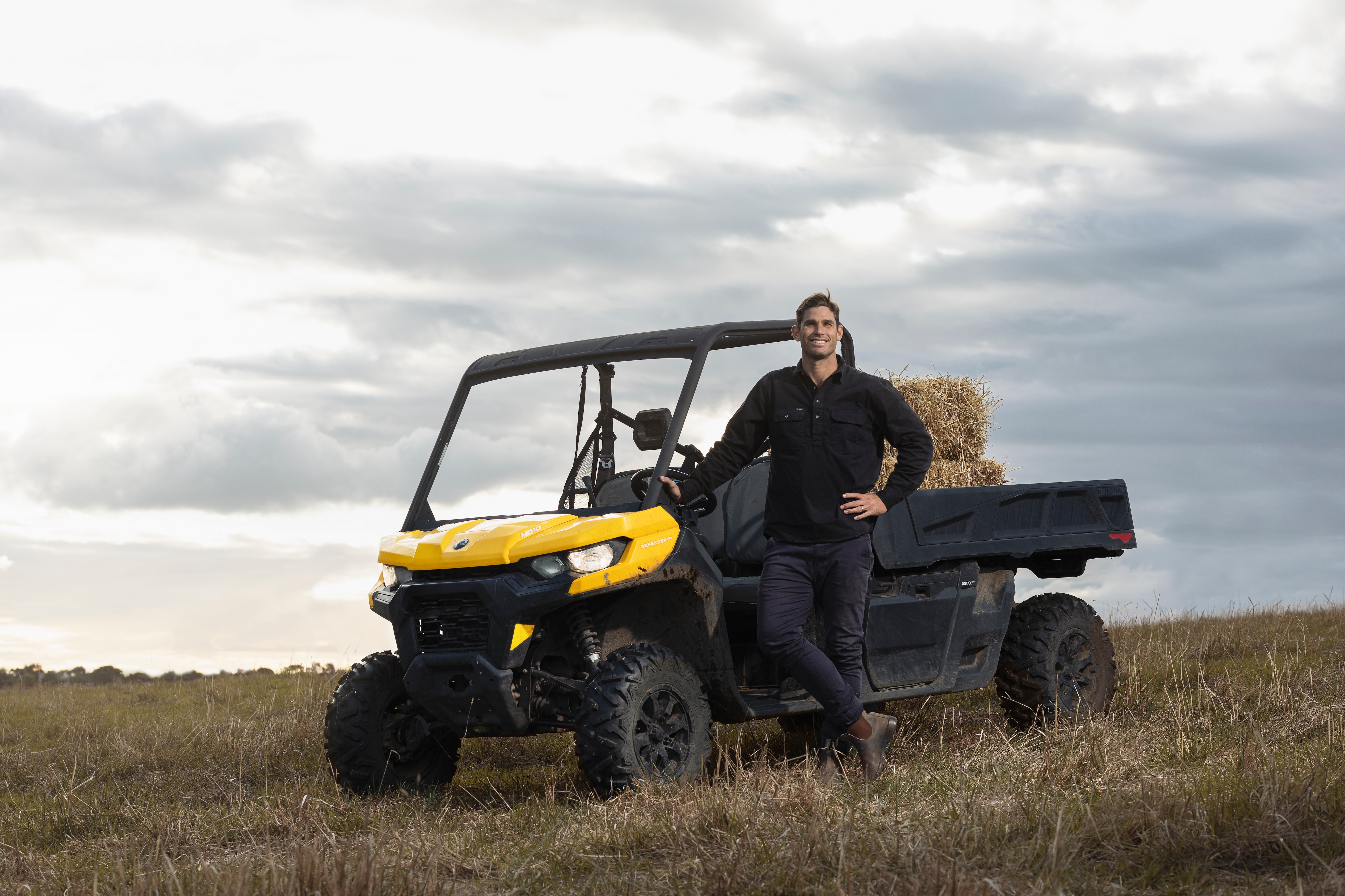 Tom Hawkins standing next to Can-Am Defender