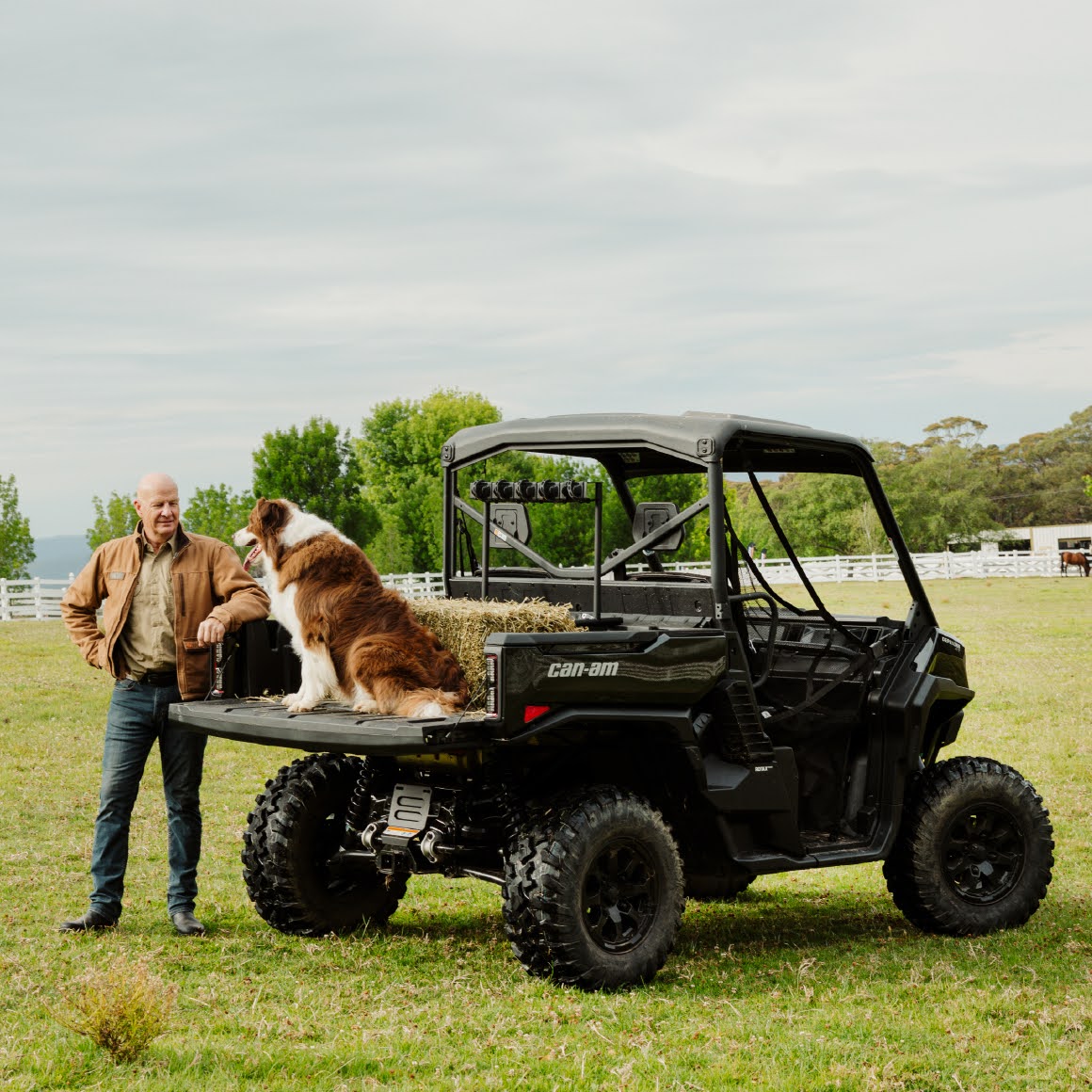 Sir David Fagan standing next to a Can-Am Defender