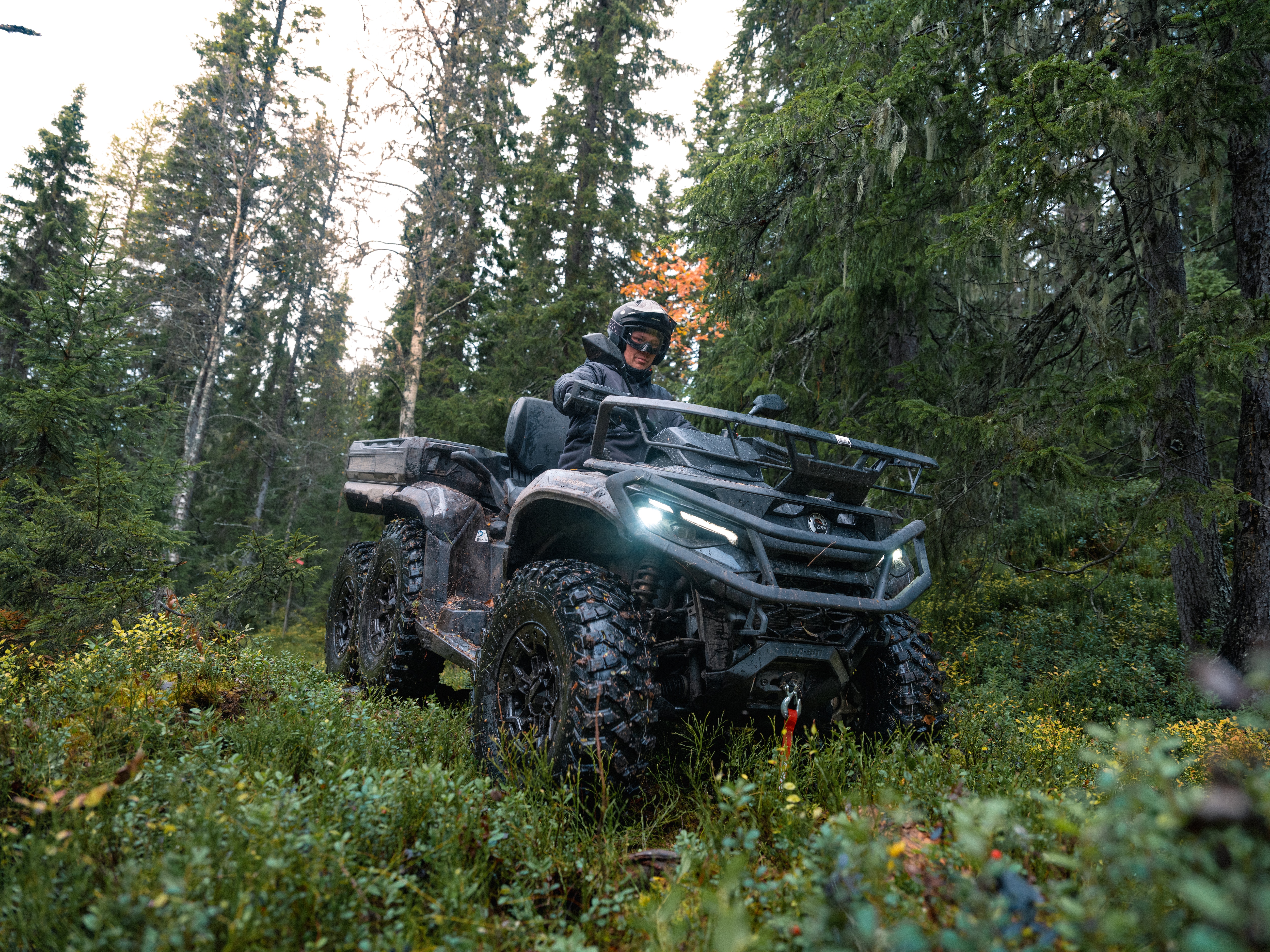 Can-Am Outlander MAX 6X6 riding in the middle of a forest