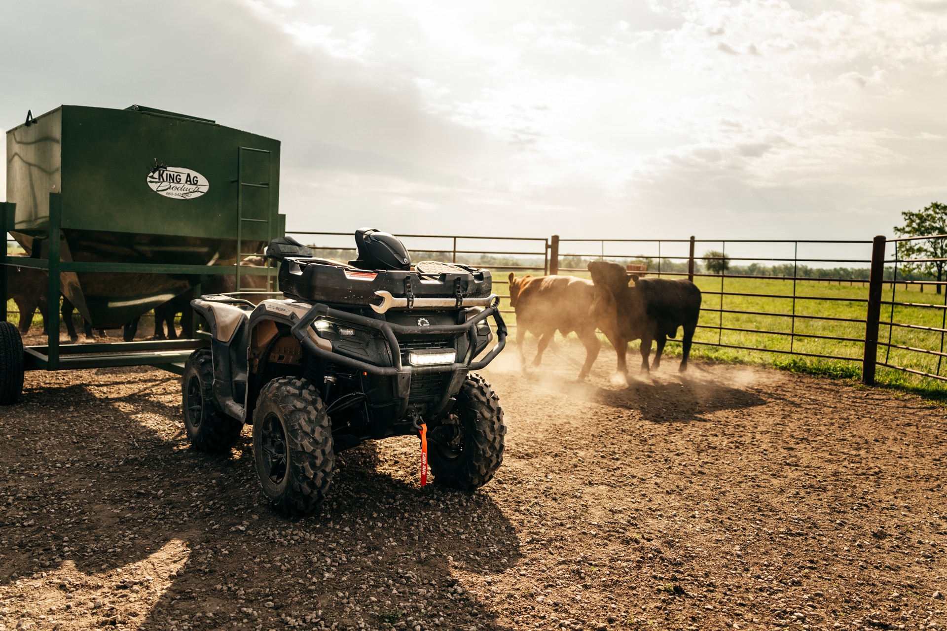 2027 Can-Am Outlander PRO ATV equipped with a LinQ Cargo Basket in the middle of a cow pen