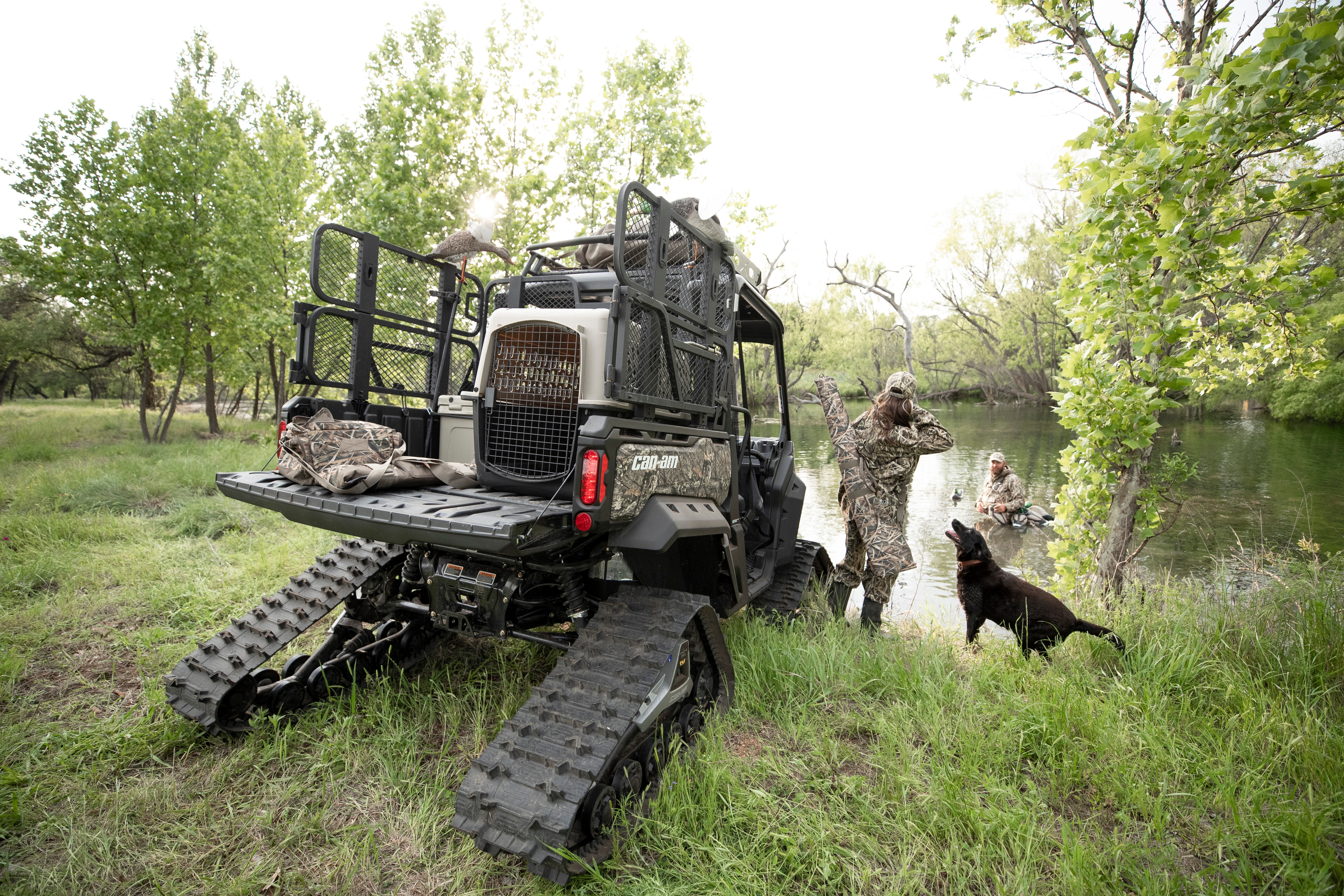 A hunting couple ready for their activity with a well-equipped Can-Am Defender