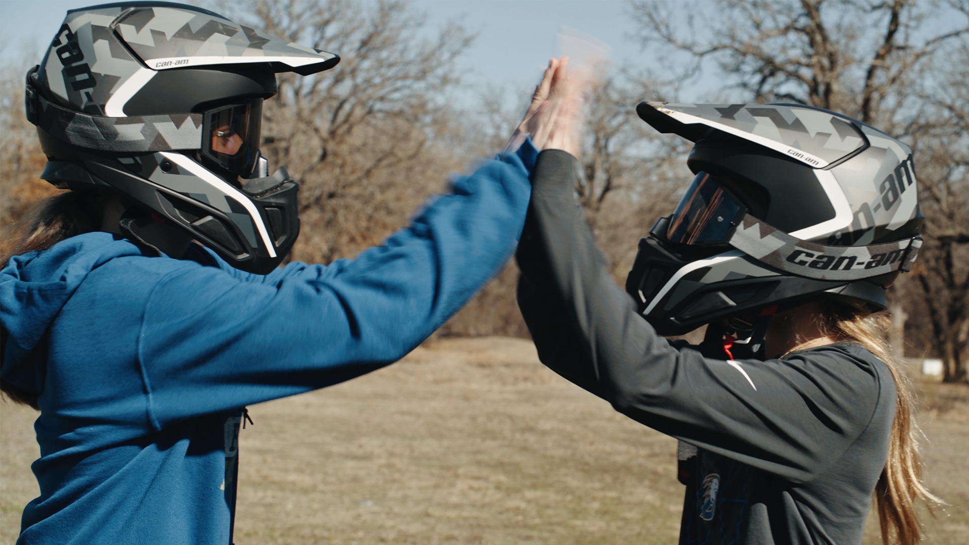 Riders wearing Off-Road Helmets giving each other a high five