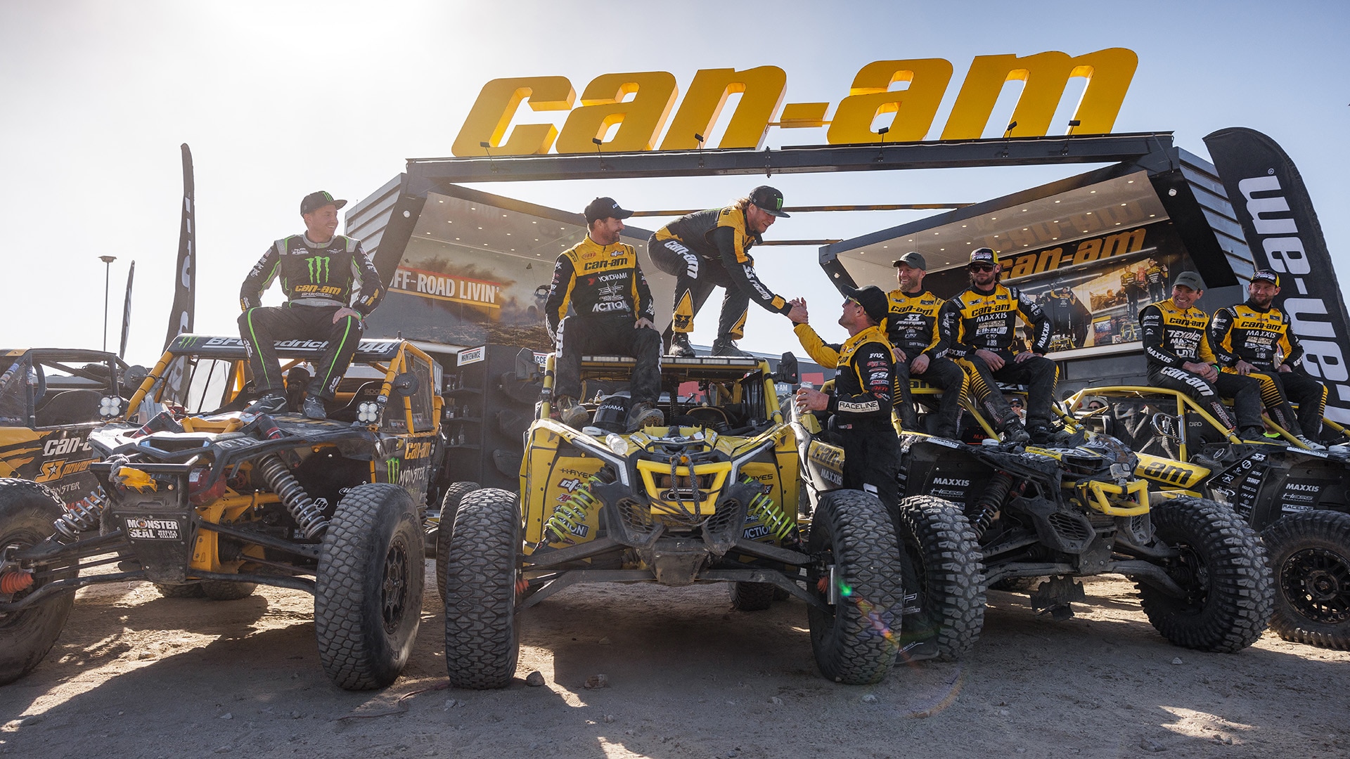 Can-Am Off-Road riders celebrating another win with their Maverick SxS vehicles