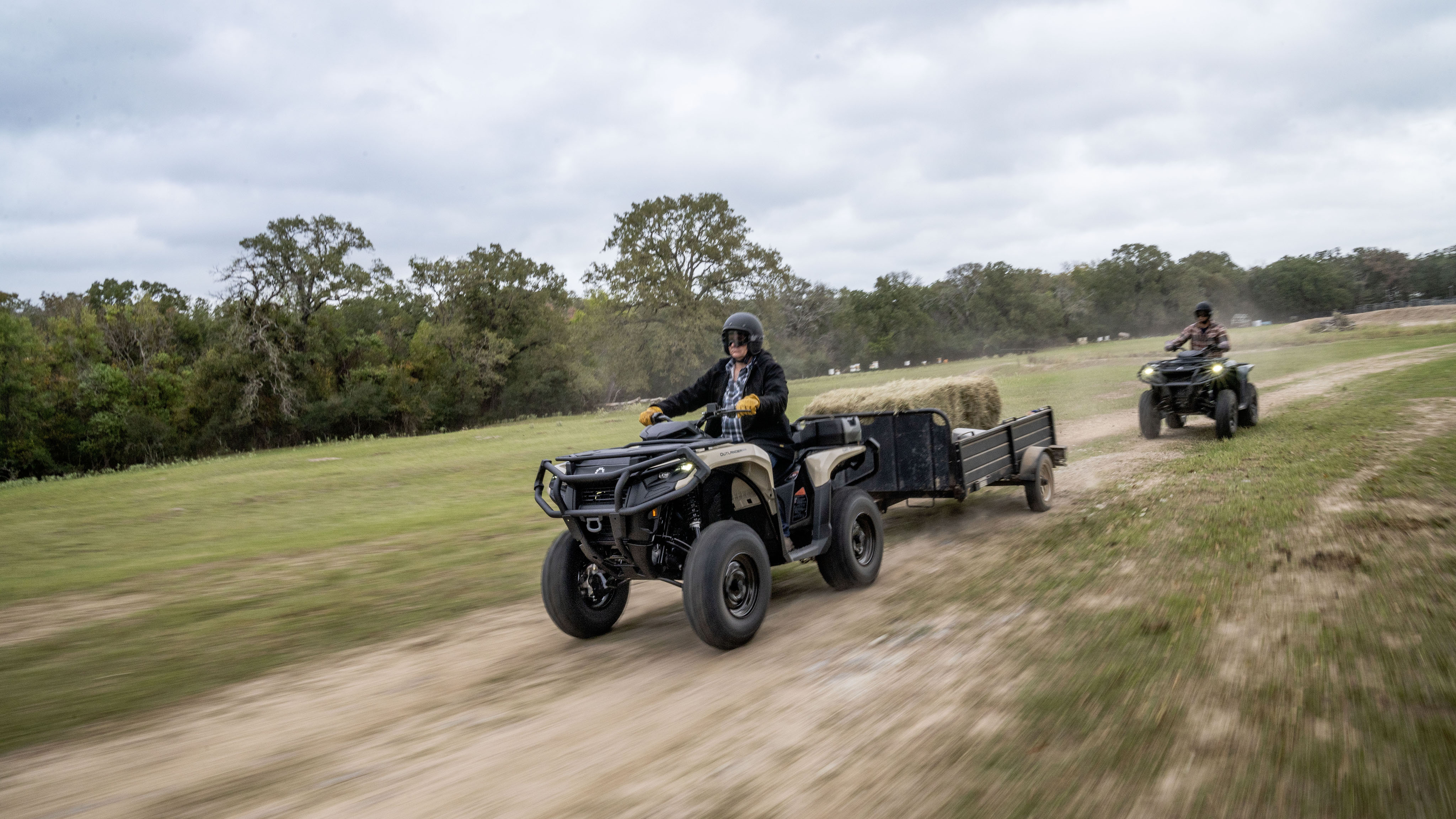 2 farmers riding on their Can-Am Outlander Pro