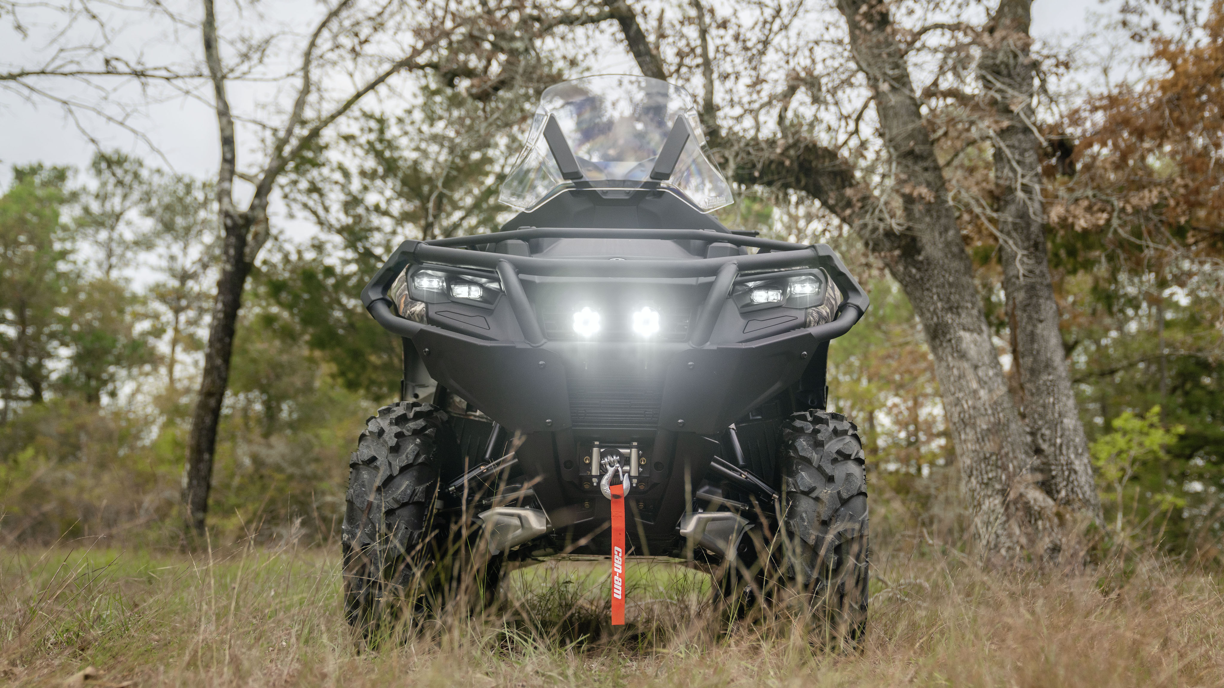 Front view of a Can-Am Outlander PRO Hunting Edition in a forest setting