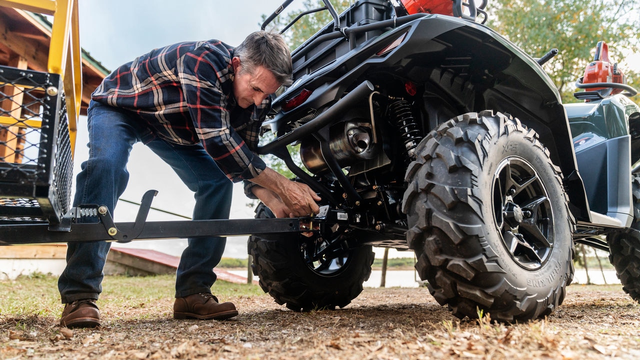 Man hitching trailer to a Can-Am Outlander PRO ATV