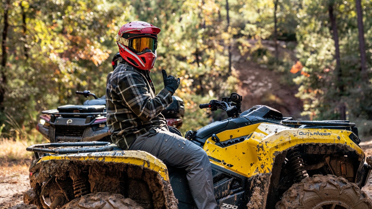A driver on their Can-Am Outlander 500/700 in the forest