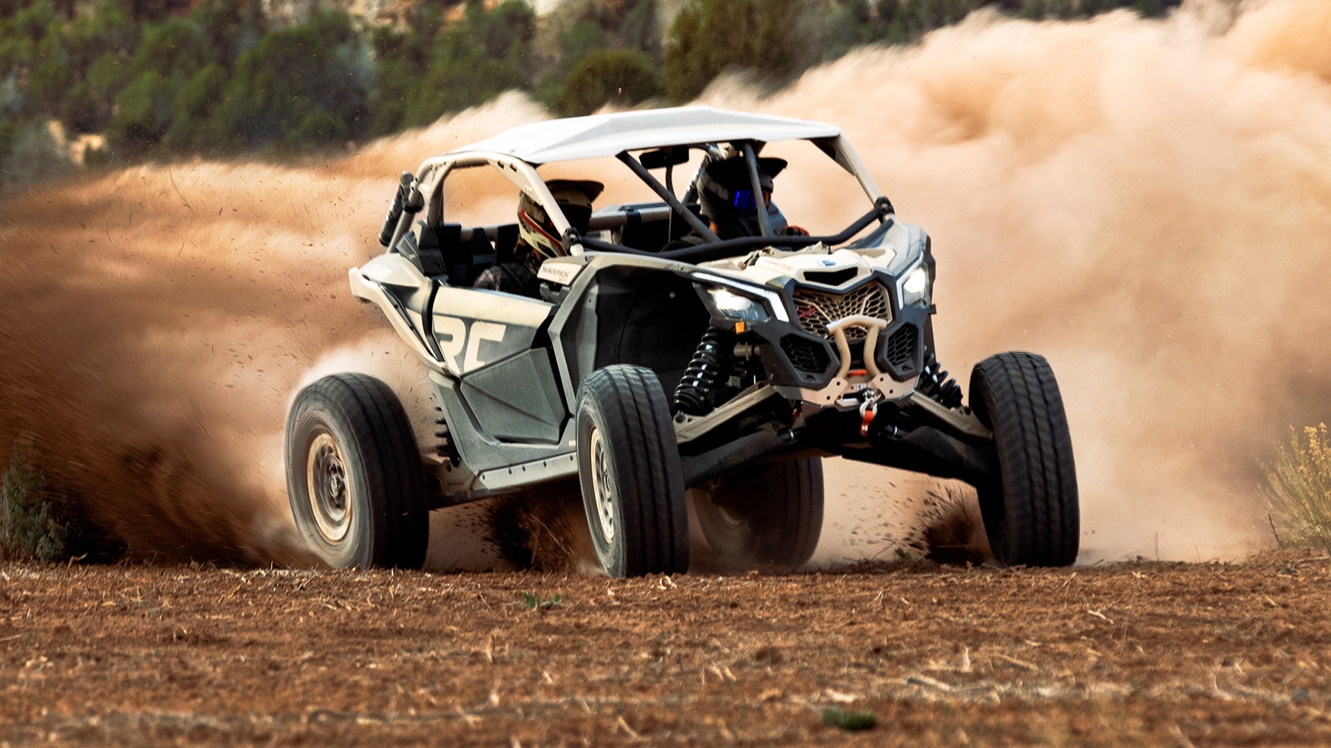 A Can-Am Maverick X3 RR riding out in a field