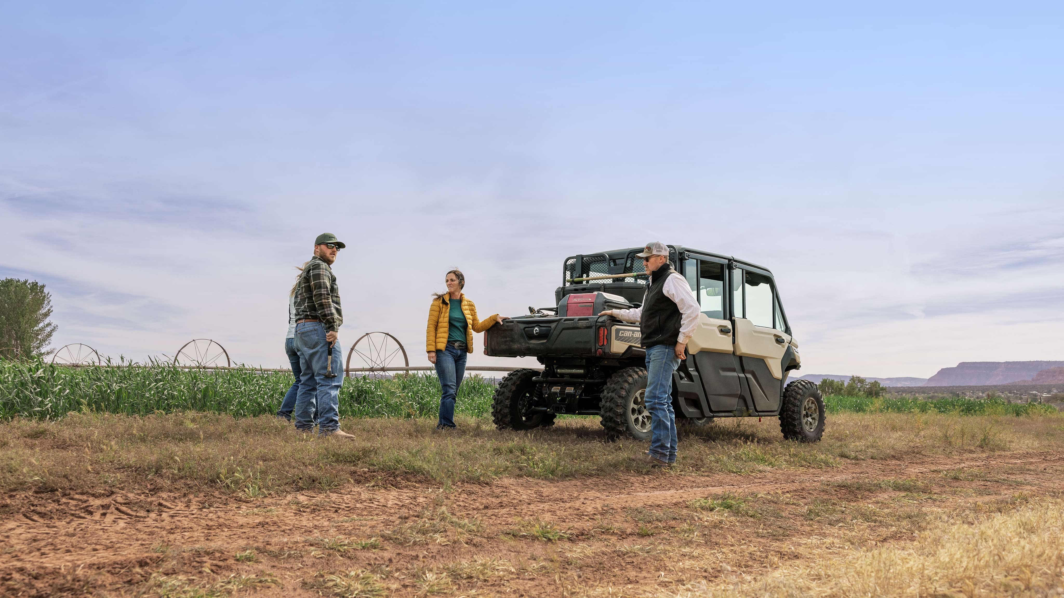 A group of people around a Defender