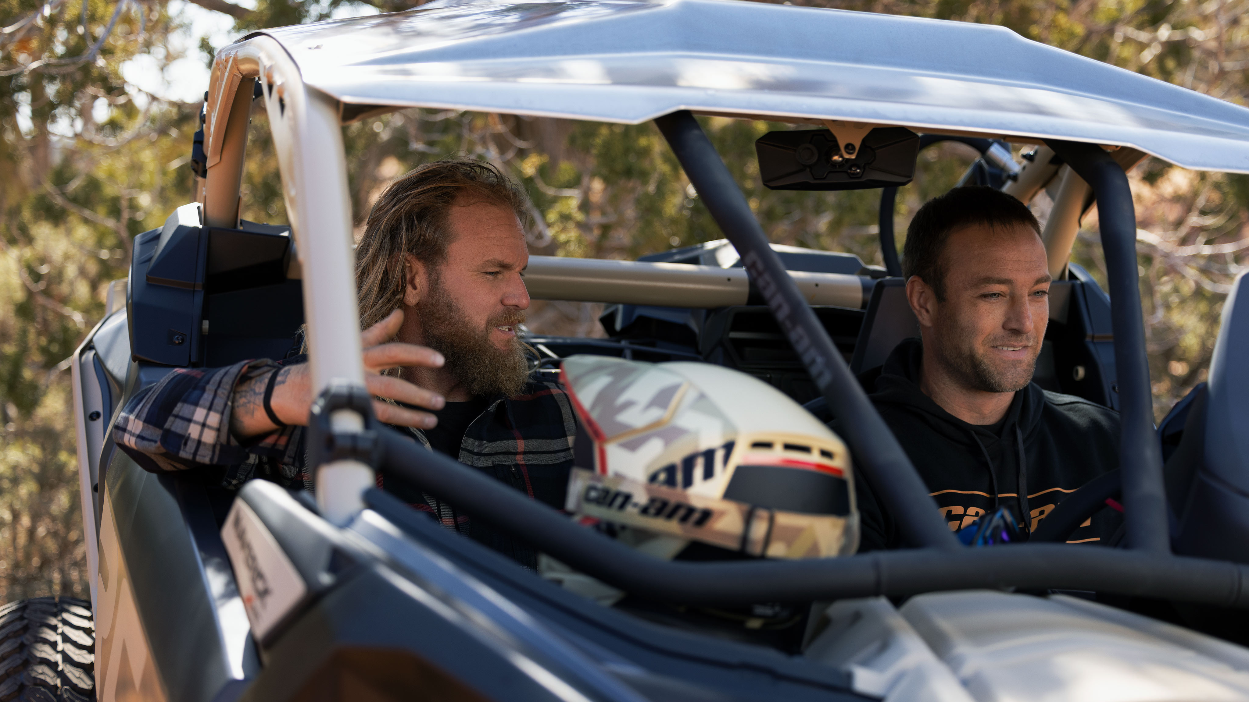 Two men sitting in a Can-Am Maverick X3