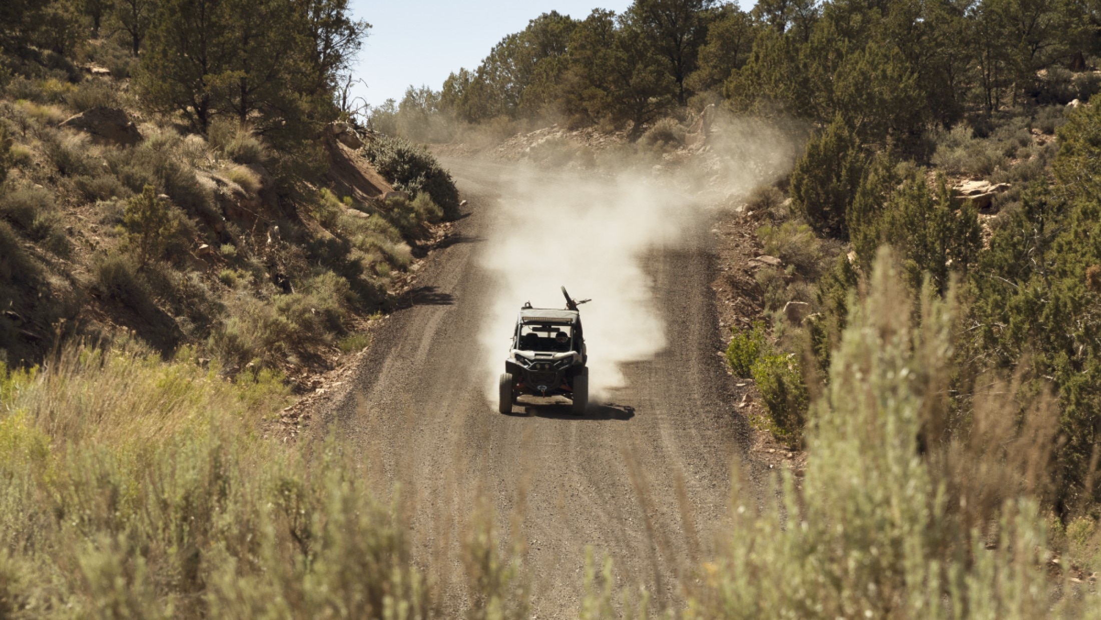 Can-AM Commander driving on a dirt road