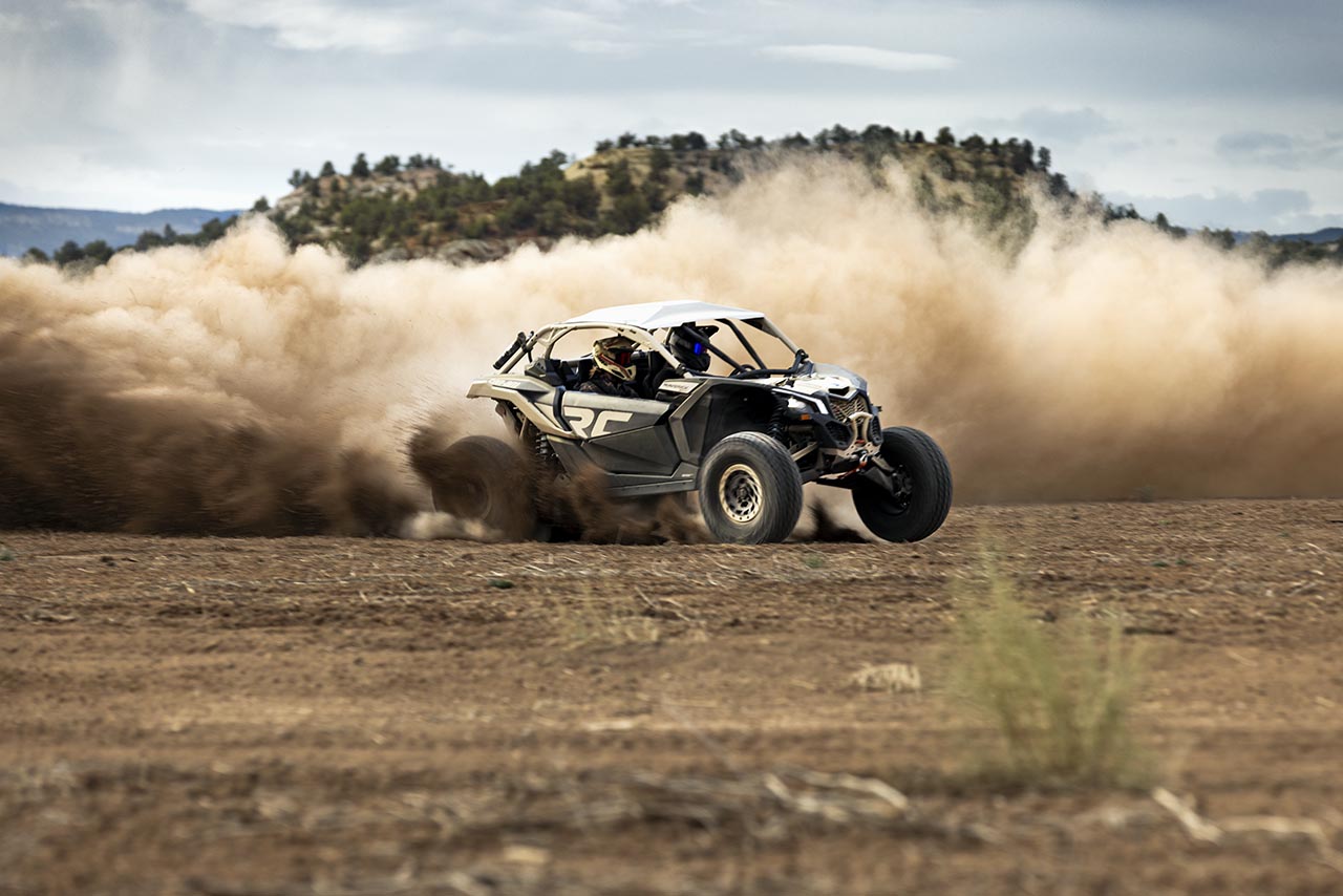 A mineral grey and desert tan Can-Am Maverick X3 X RC Turbo RR 72  kicking up dust.