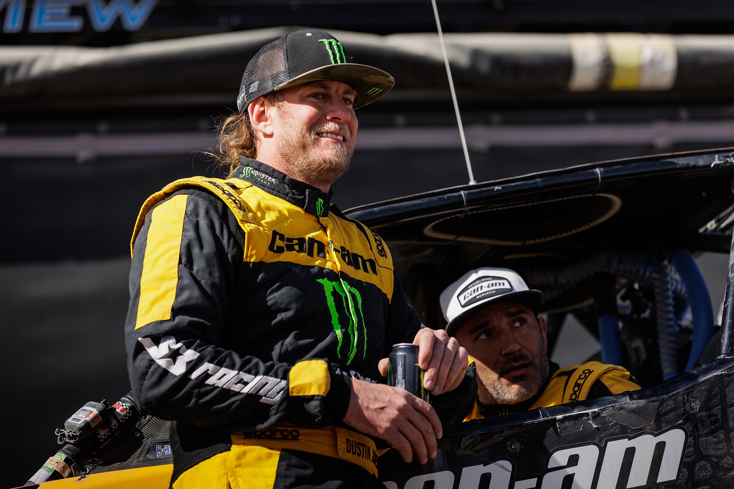 Can-Am Off-Road rider Dustin Jones discussing with a teammate at the 2024 King of the Hammers