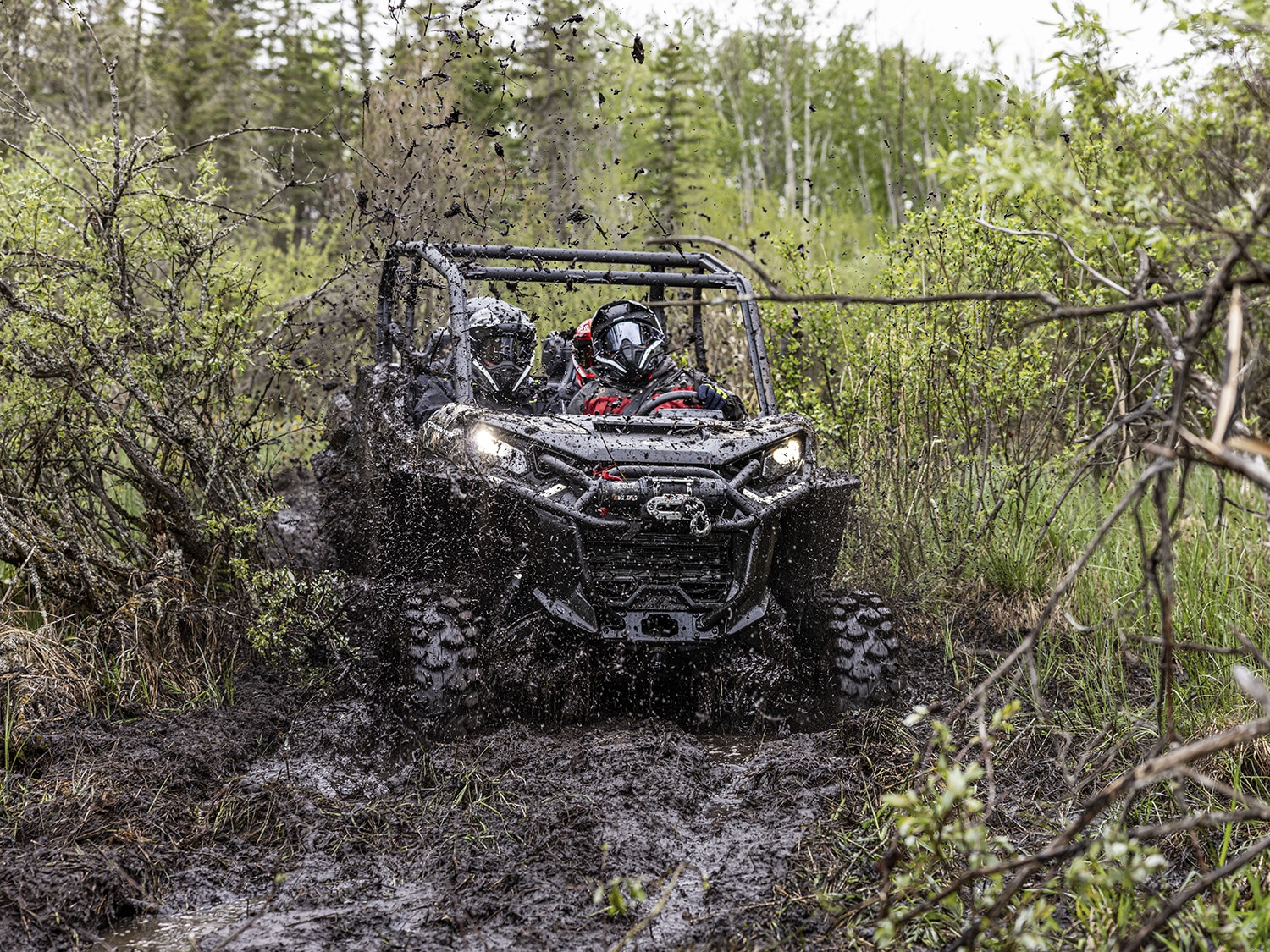 2024 Can-Am Commander MAX X MR SxS vehicle riding in deep mud