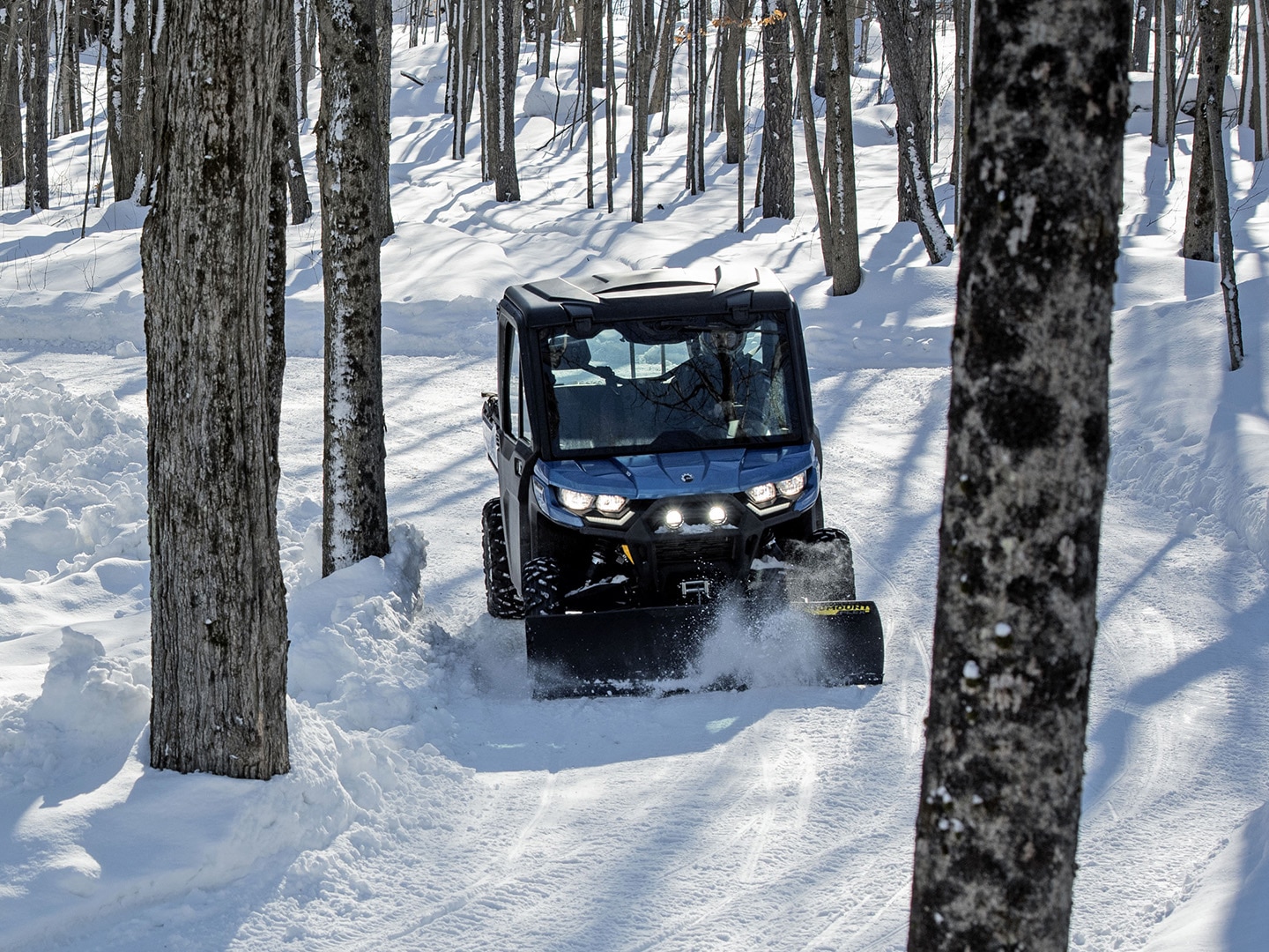 Can-Am Defender side-by-side vehicle plowing snow