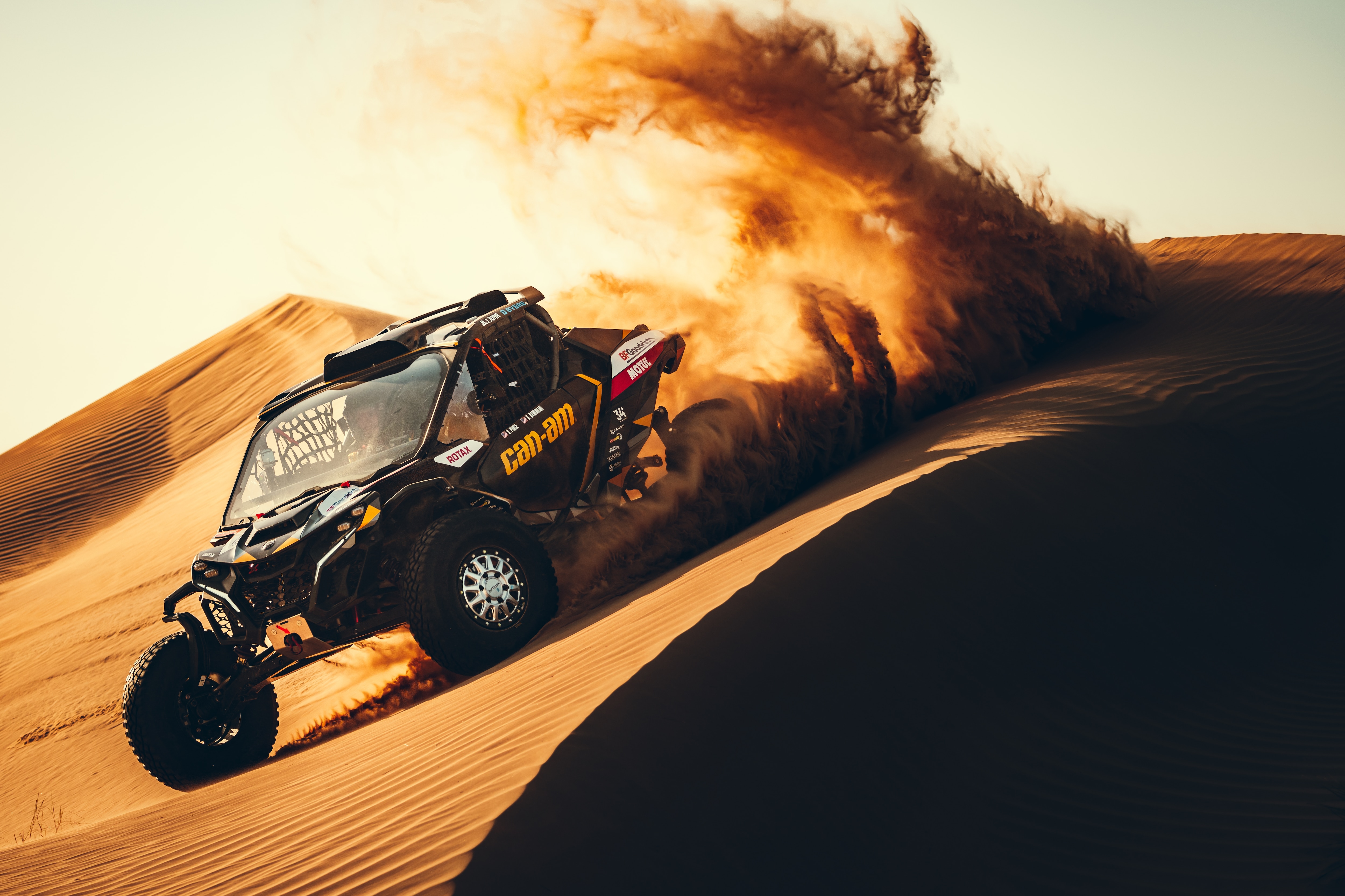 Maverick R driving on a sand dune