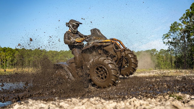Rider driving a 2025 Can-Am Renegade X MR ATV in deep mud