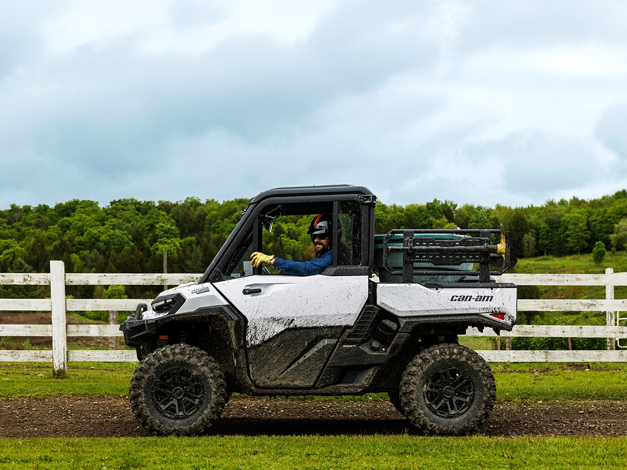 A Can-Am Defender DPS HD7 side-by-side working on a farm 