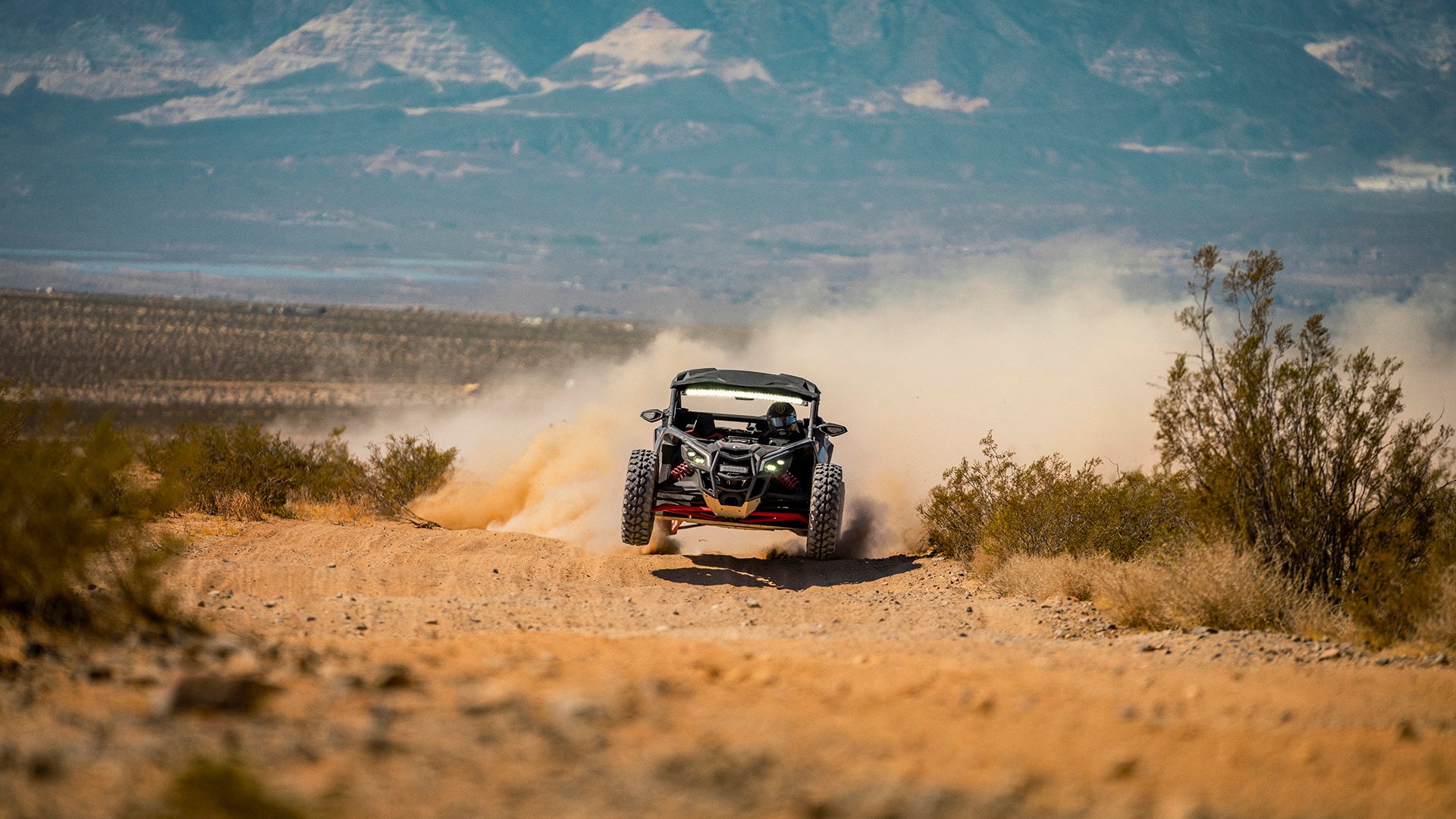 A 2026 Can-Am Maverick X3 X RS rolling in the desert sand