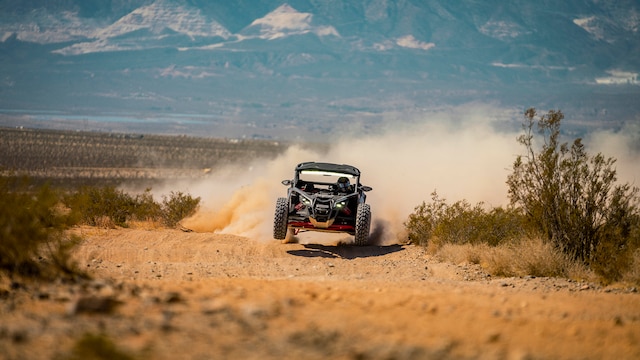A 2026 Can-Am Maverick X3 X RS rolling in the desert sand