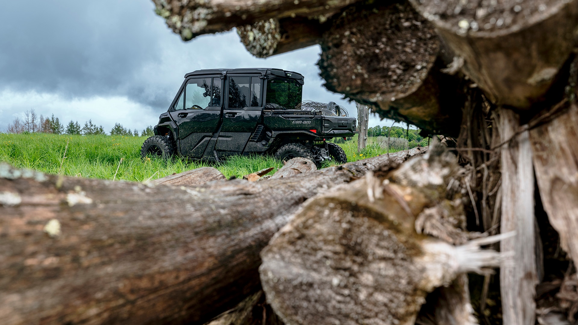 2026 Can-Am Defender HD11 Max LoneStar in the lawn, near several logs