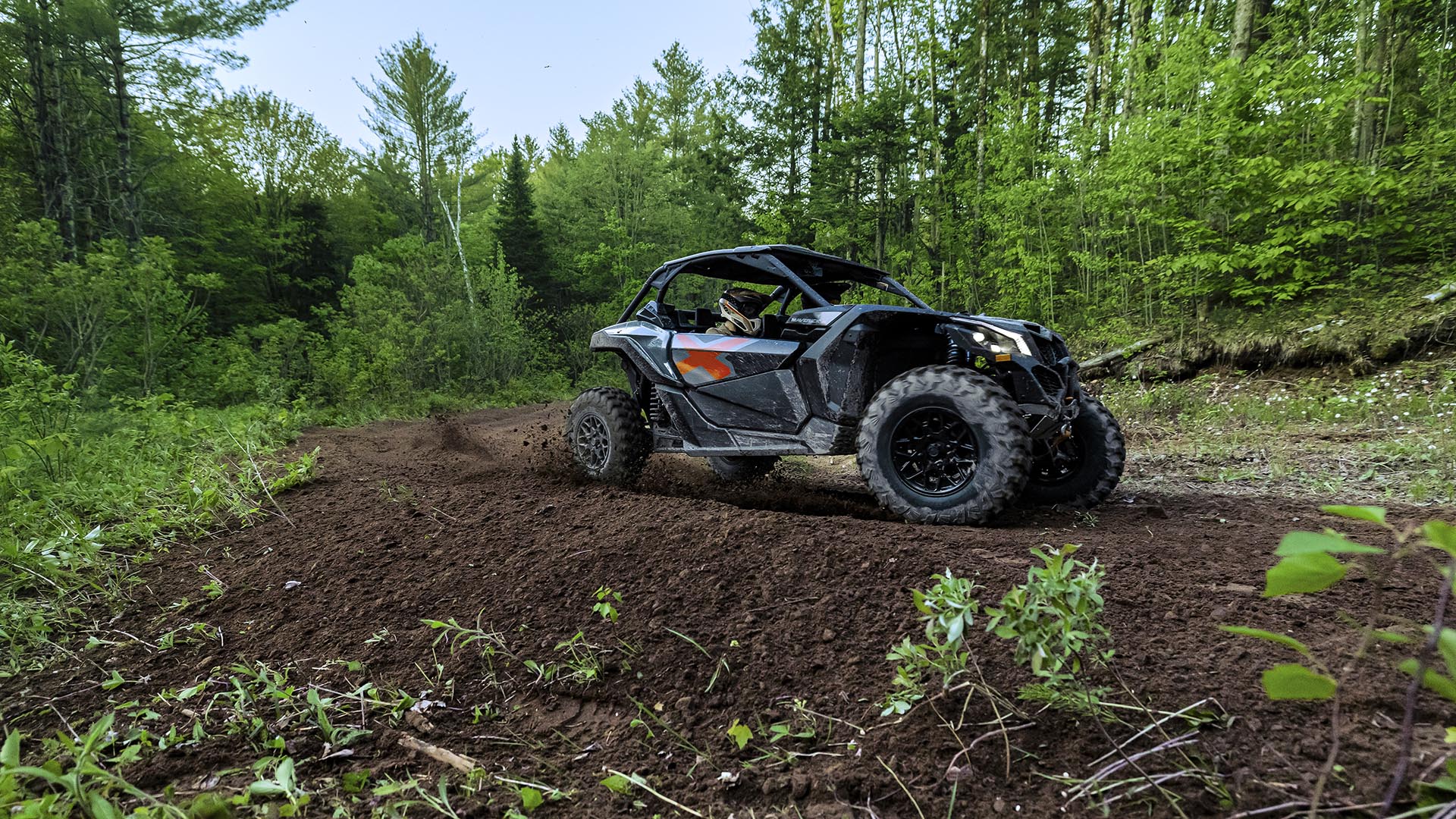 2026 Maverick X3 Turbo Granite Grey driving in the forest