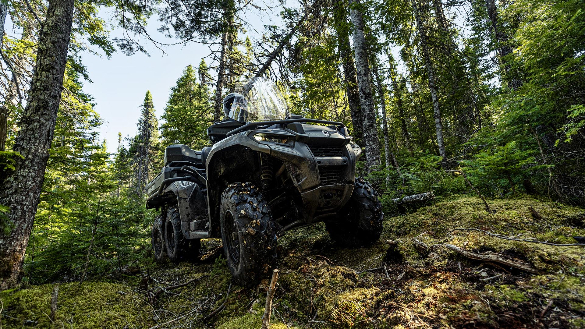 2026 Can-Am Outlander 6x6 ATV passing over rocks and obstacles