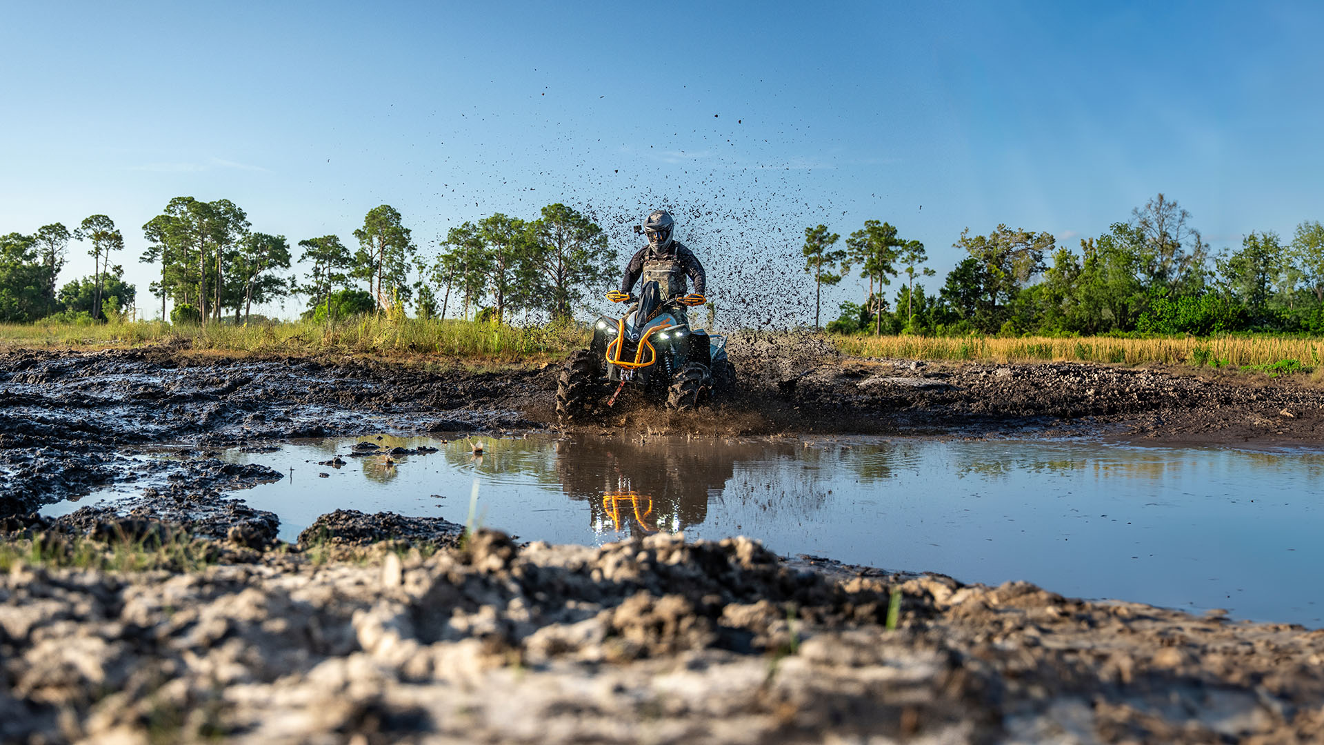 Can-Am Renegade X MR Scandi Blue entering a large mud puddle