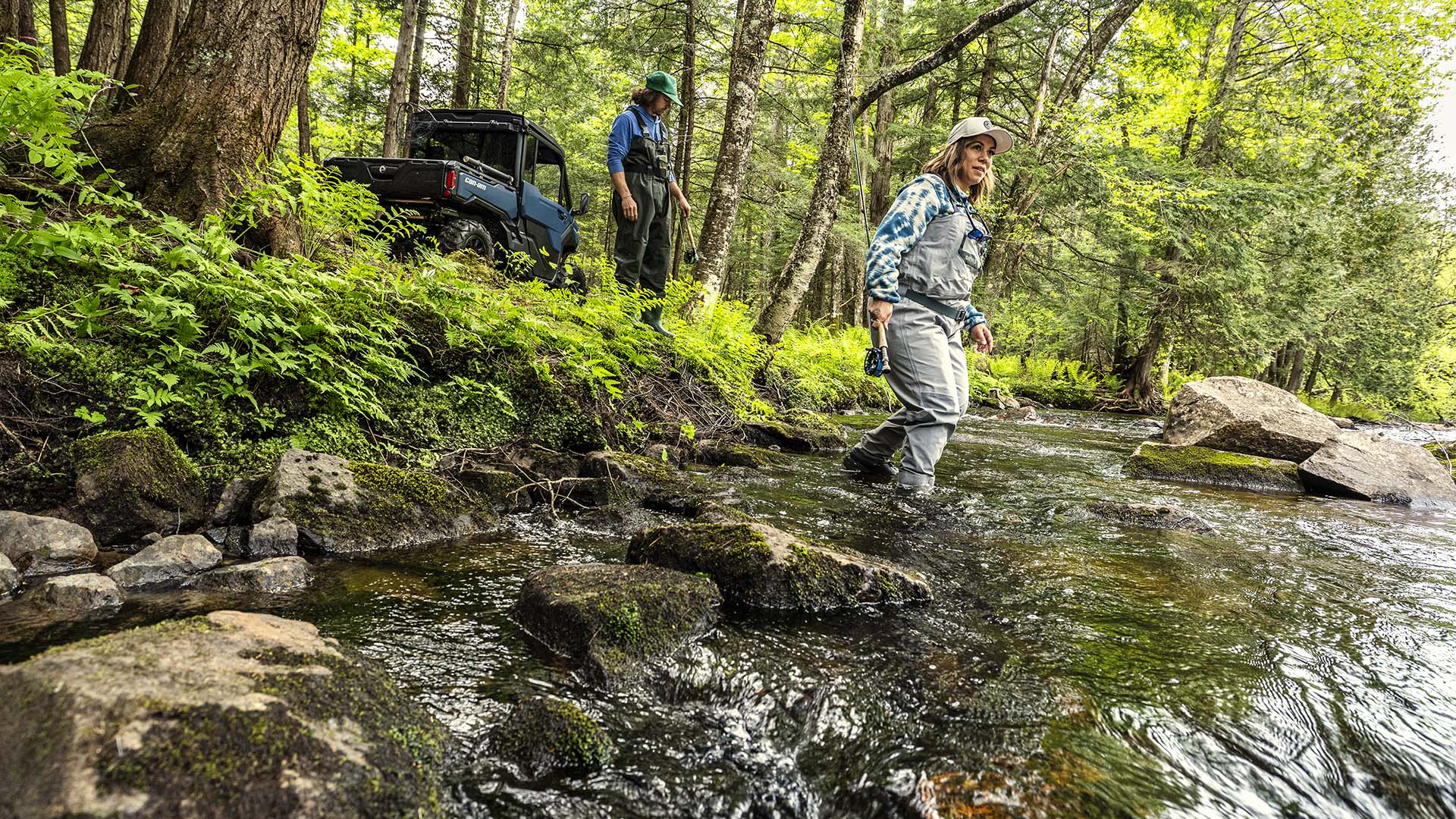 2026 Can-Am Defender XT dusty navy side-by-side parked near water in the forest