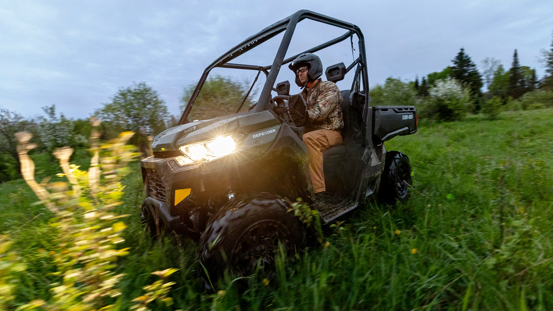 A Can-Am Defender side-by-side in the grass