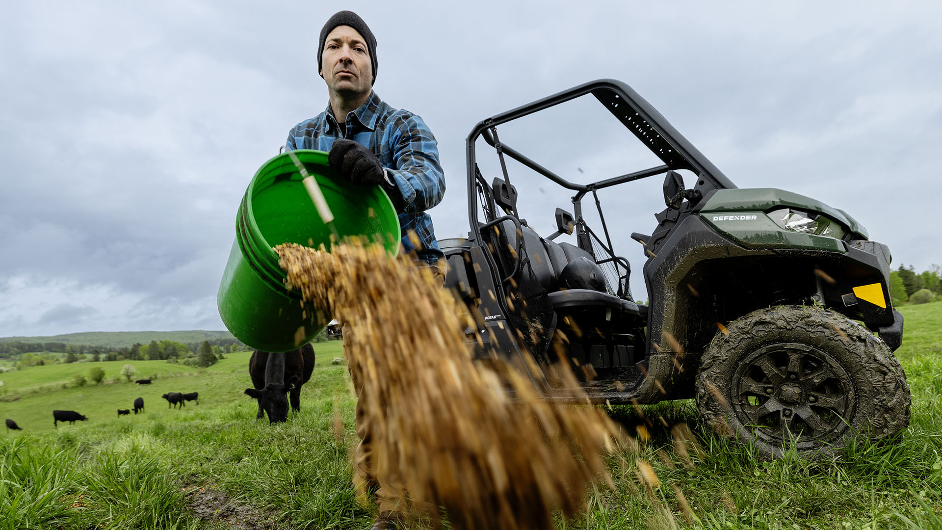 A worker dropping food for his animals near his 2026 Can-Am Defender DPS HD7