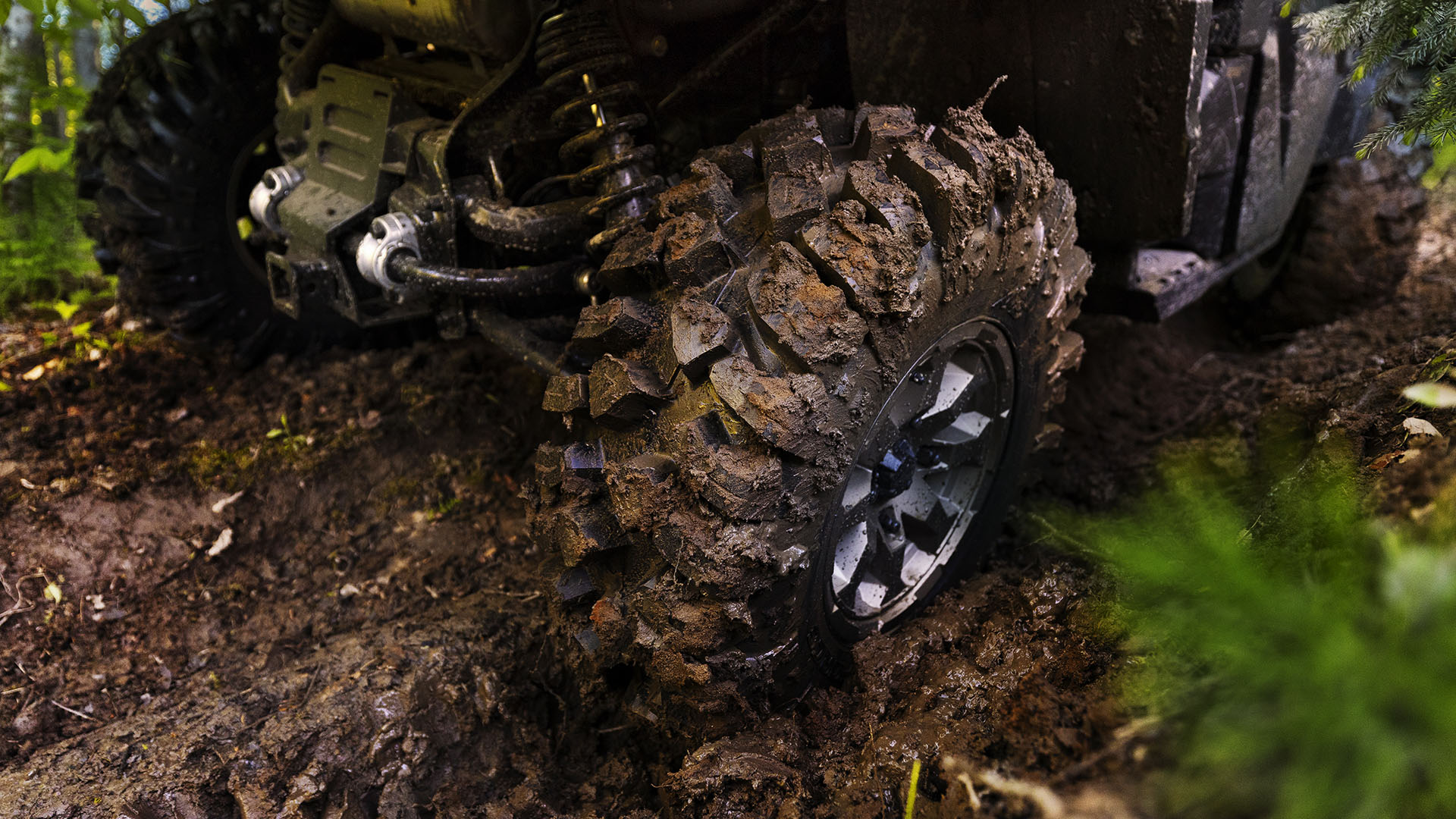 Close up view of the mud-covered tires from the 2026 Can-Am Defender HD11 X mr 
