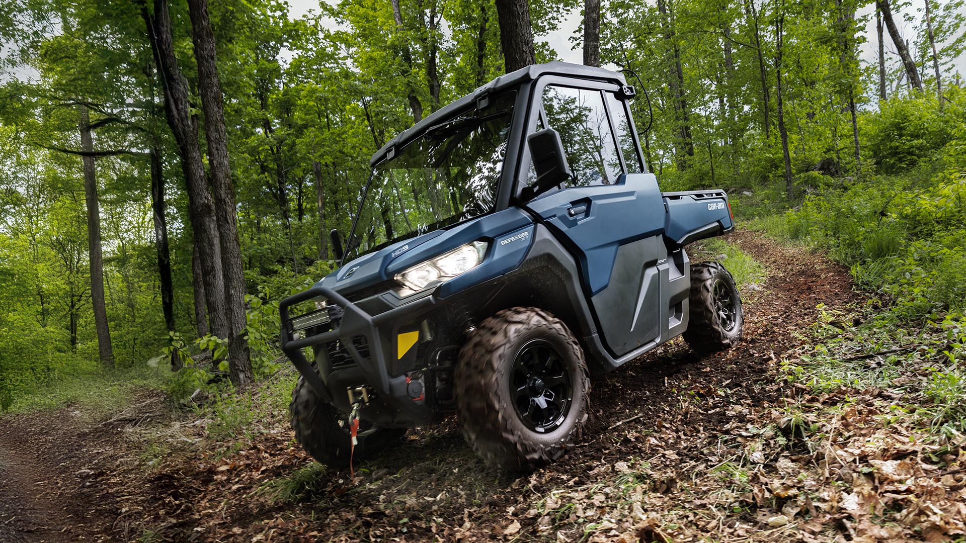 2026 Can-Am Defender XT HD-9 riding down in a forest