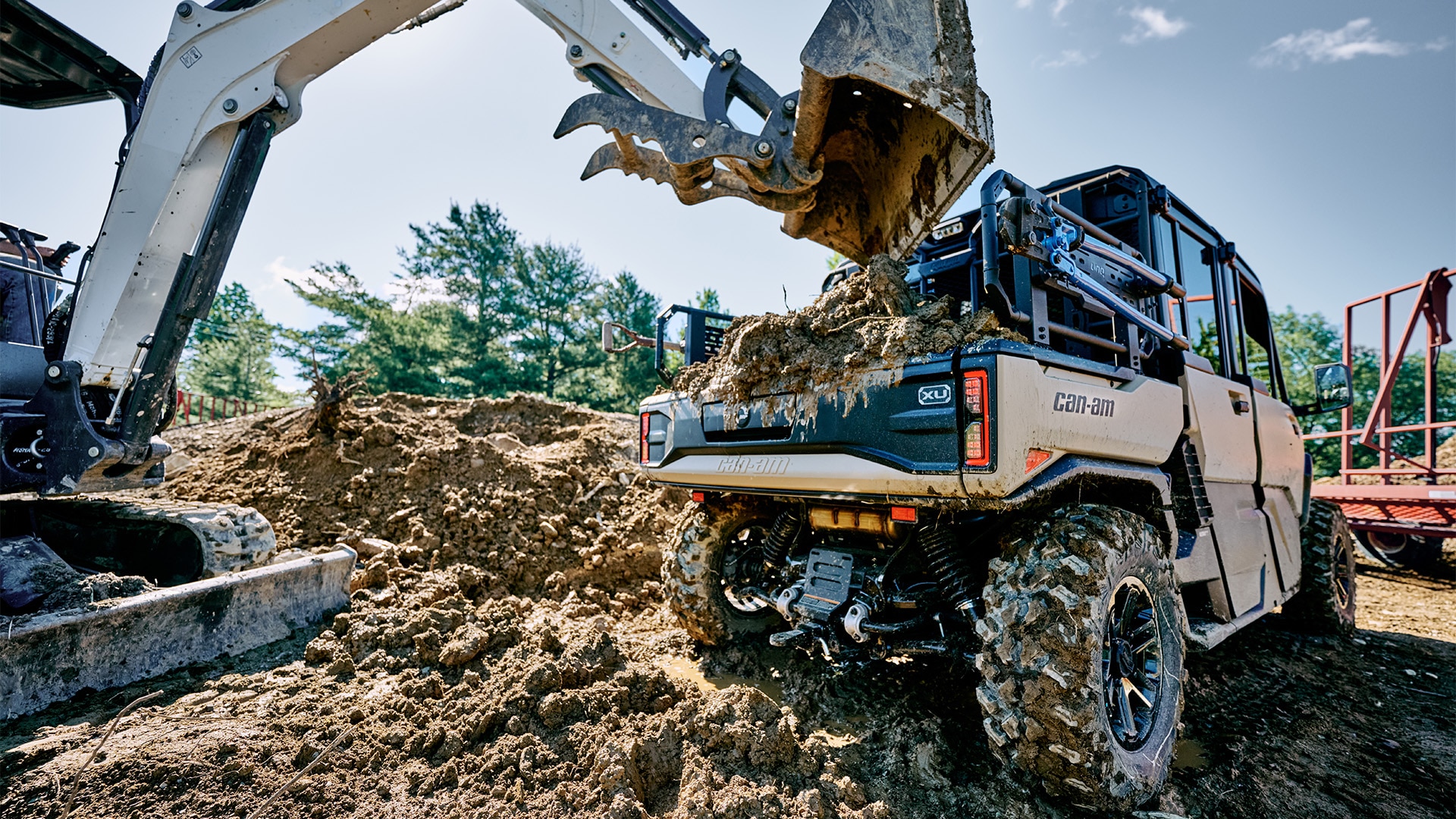 Le tout nouveau Can-Am Defender XU HD10/HD11 2027, dont le coffre est en train d'être chargé sur un chantier de construction