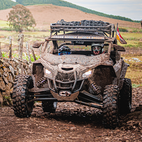 Um veículo Can-Am posicionado em uma estrada de terra batida. 