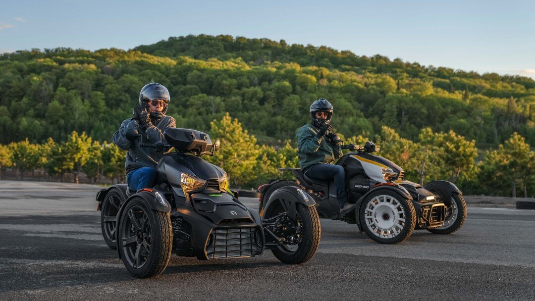 2 riders on their Can-Am Ryker with a forest in the background