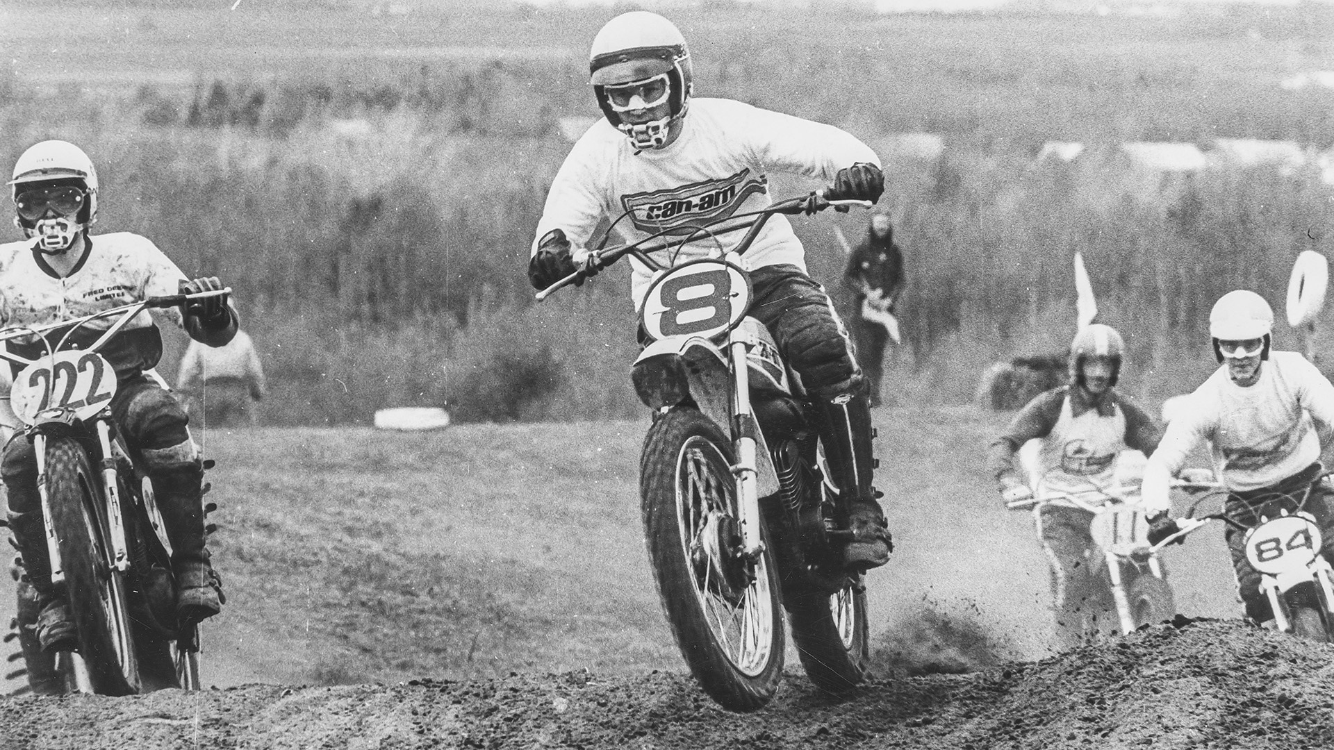 Racer driving a Can-Am motocross leading the pack of the race