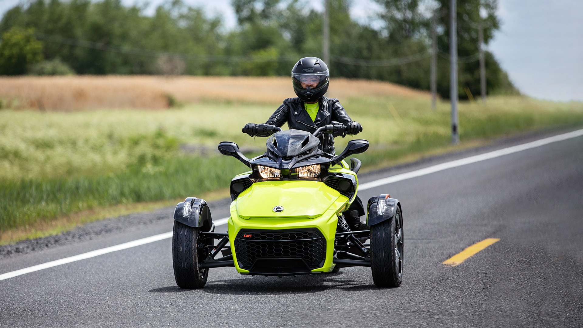 Rider driving a 2022 yellow Can-Am Spyder F3 3-wheel vehicle