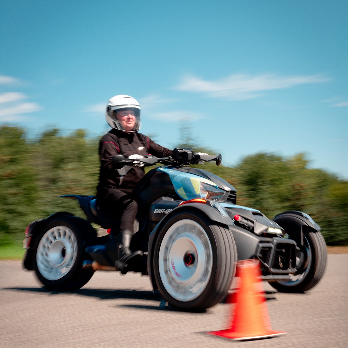 A woman taking her driving lesson aboard her Can-Am three-wheeler