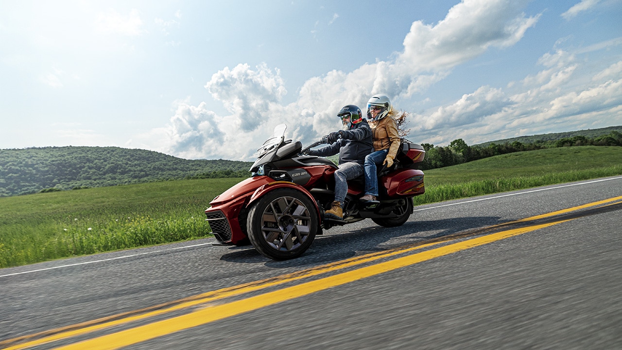 A couple riding a 2026 Can-Am 3-wheeler