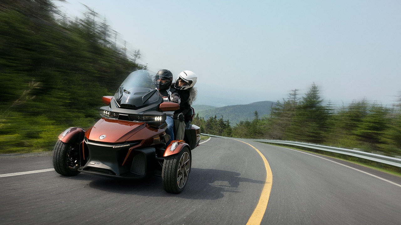 Two riders on a Can-Am Spyder RT 3-wheel motorcycle for touring 
