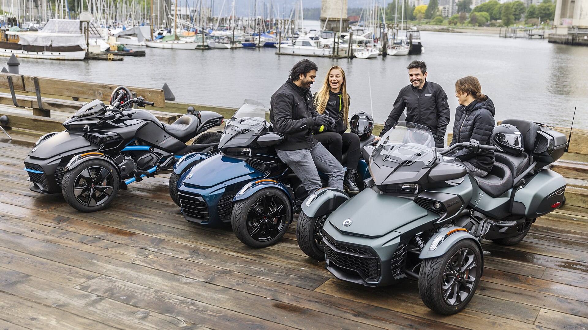 friends hanging next to their Can-Am 3-wheel vehicle in a marina