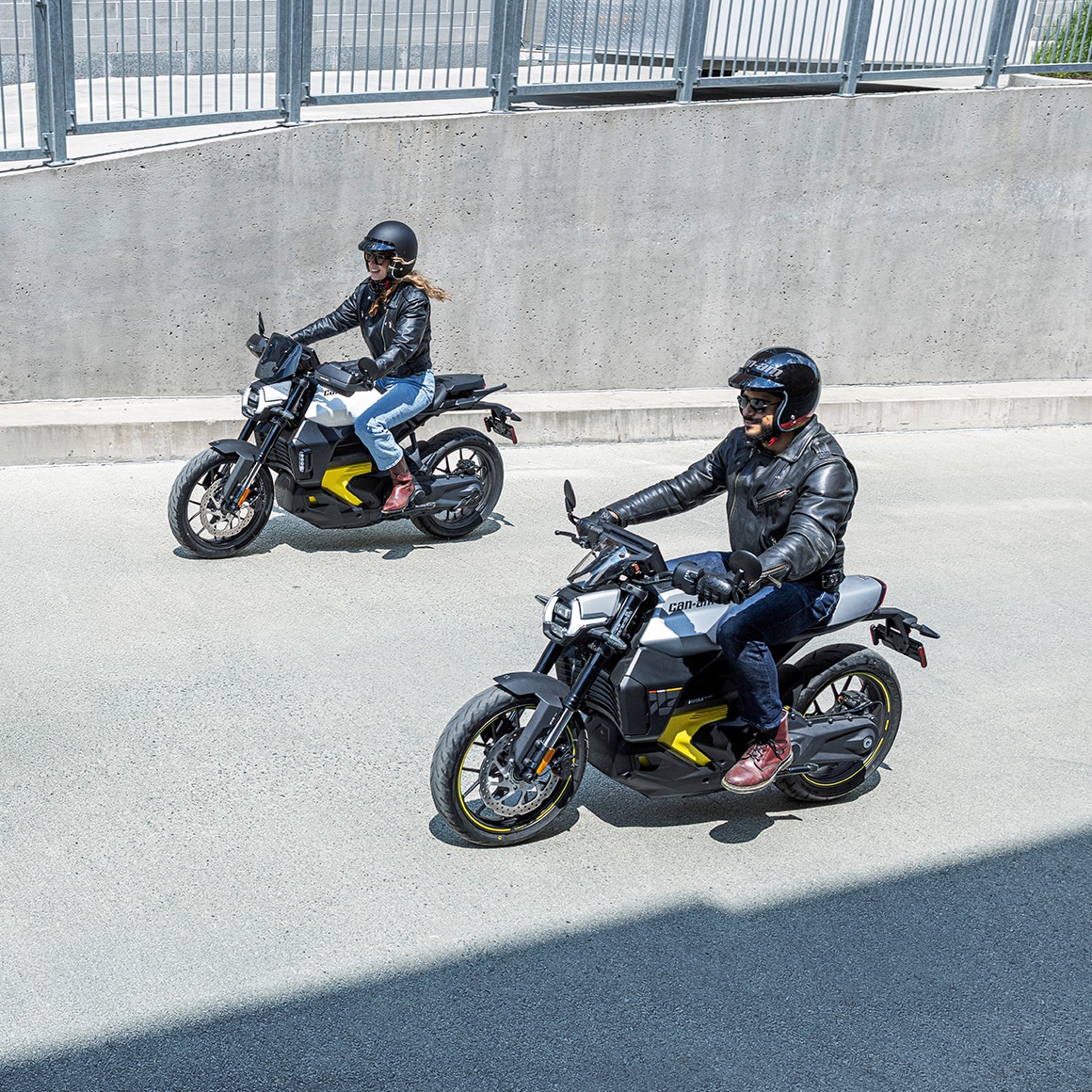 Two motorcyclists on their Can-Am Pulse on the street