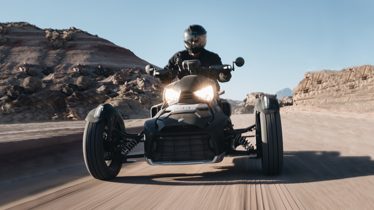 Can-Am Ryker cruising on a dirt road.