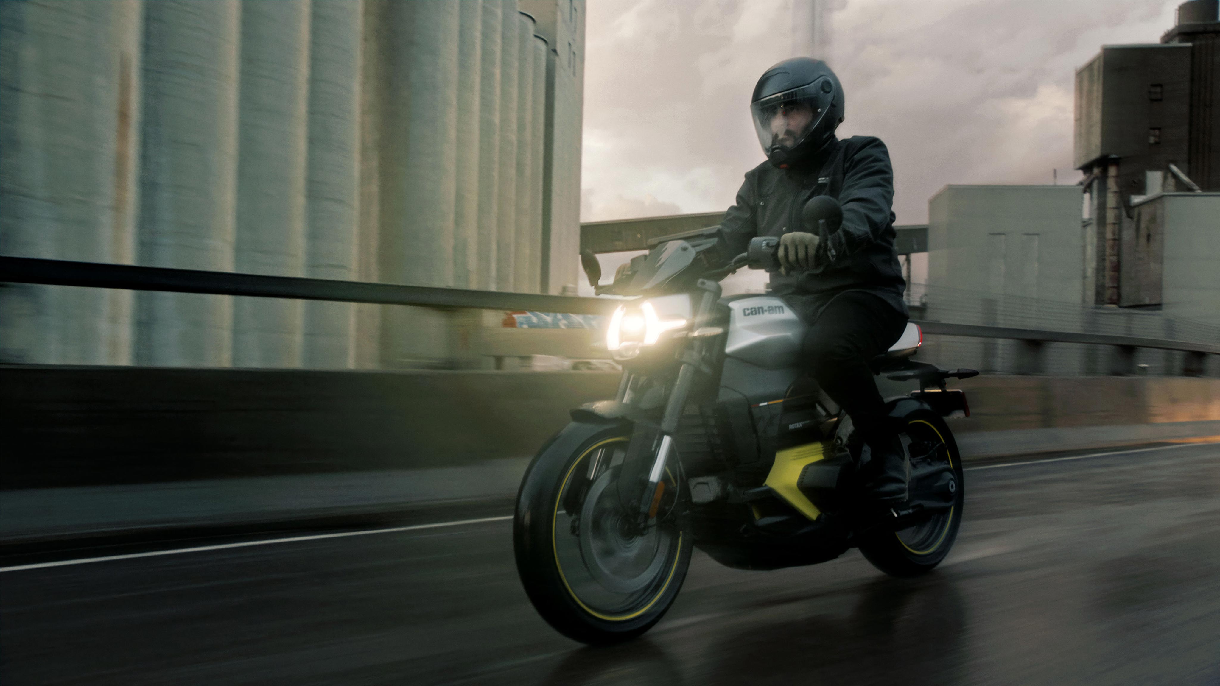 A rider riding his Can-Am electric motorcycle on the road at full speed