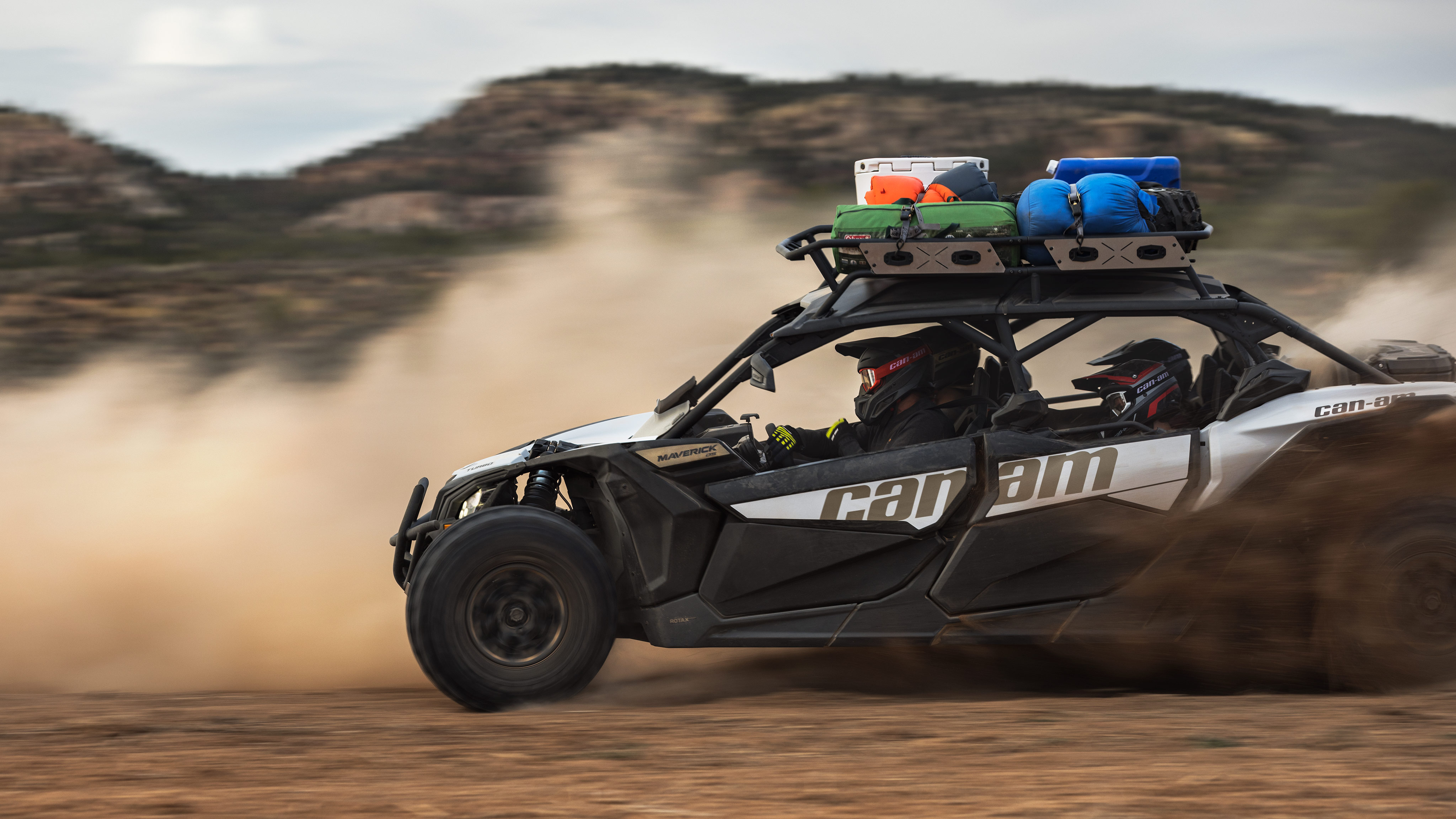 A Catalyst Grey Can-Am Maverick X3 MAX DS Turbo loaded with gear on a desert expedition