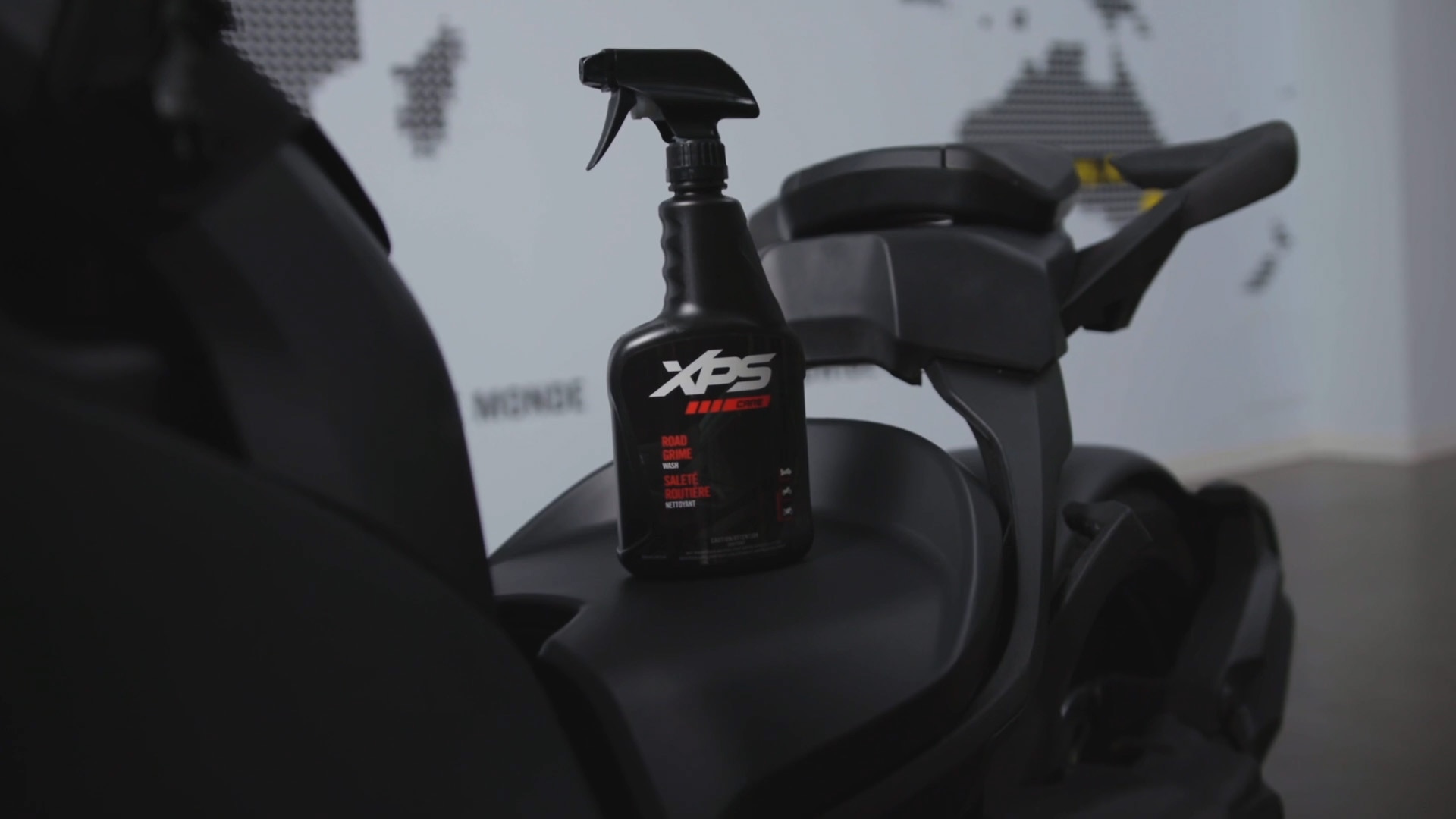 A bottle of XPS product on the seat of a Can-Am