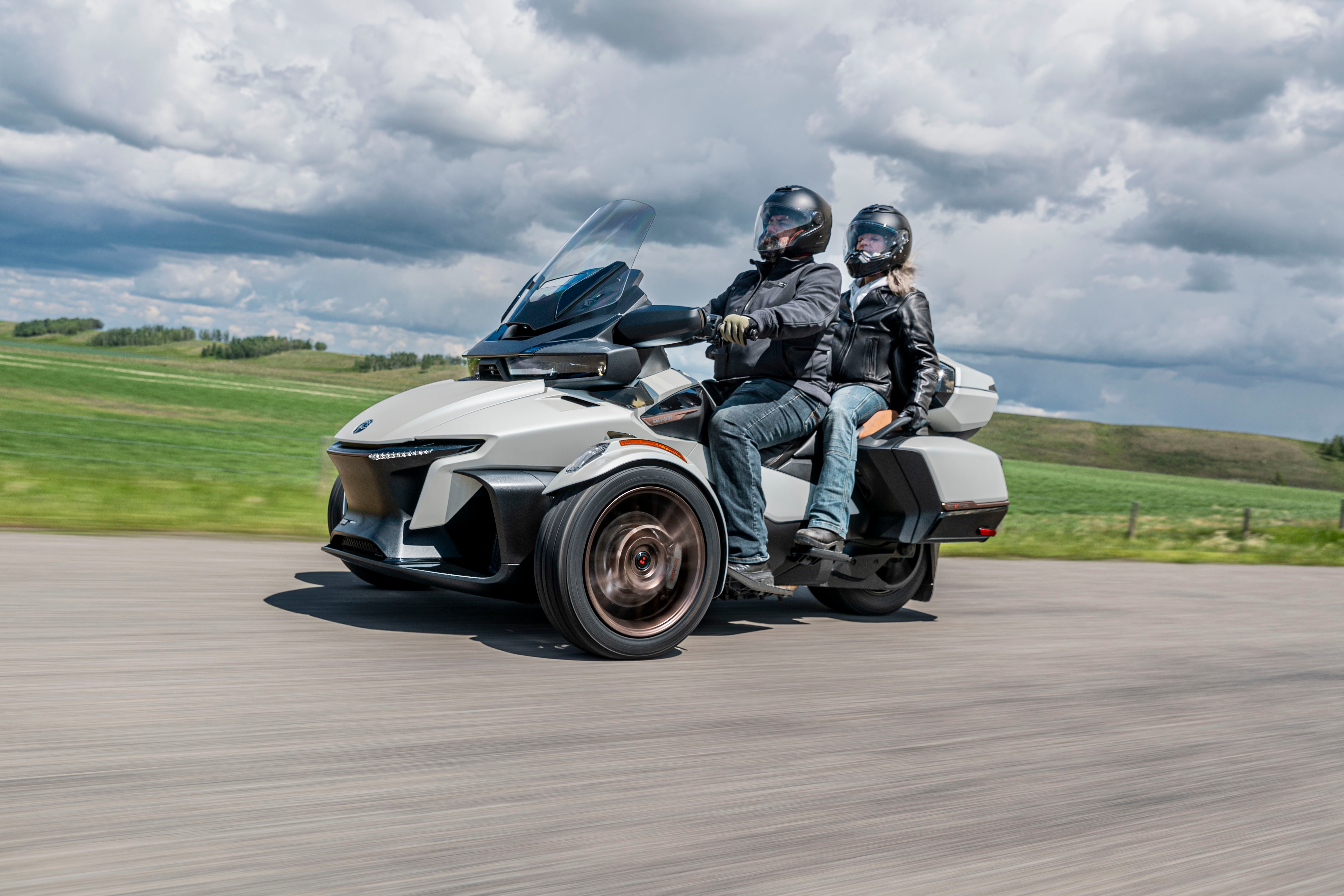 A couple riding a Can-Am Spyder RT Sea-To-Sky on the road 